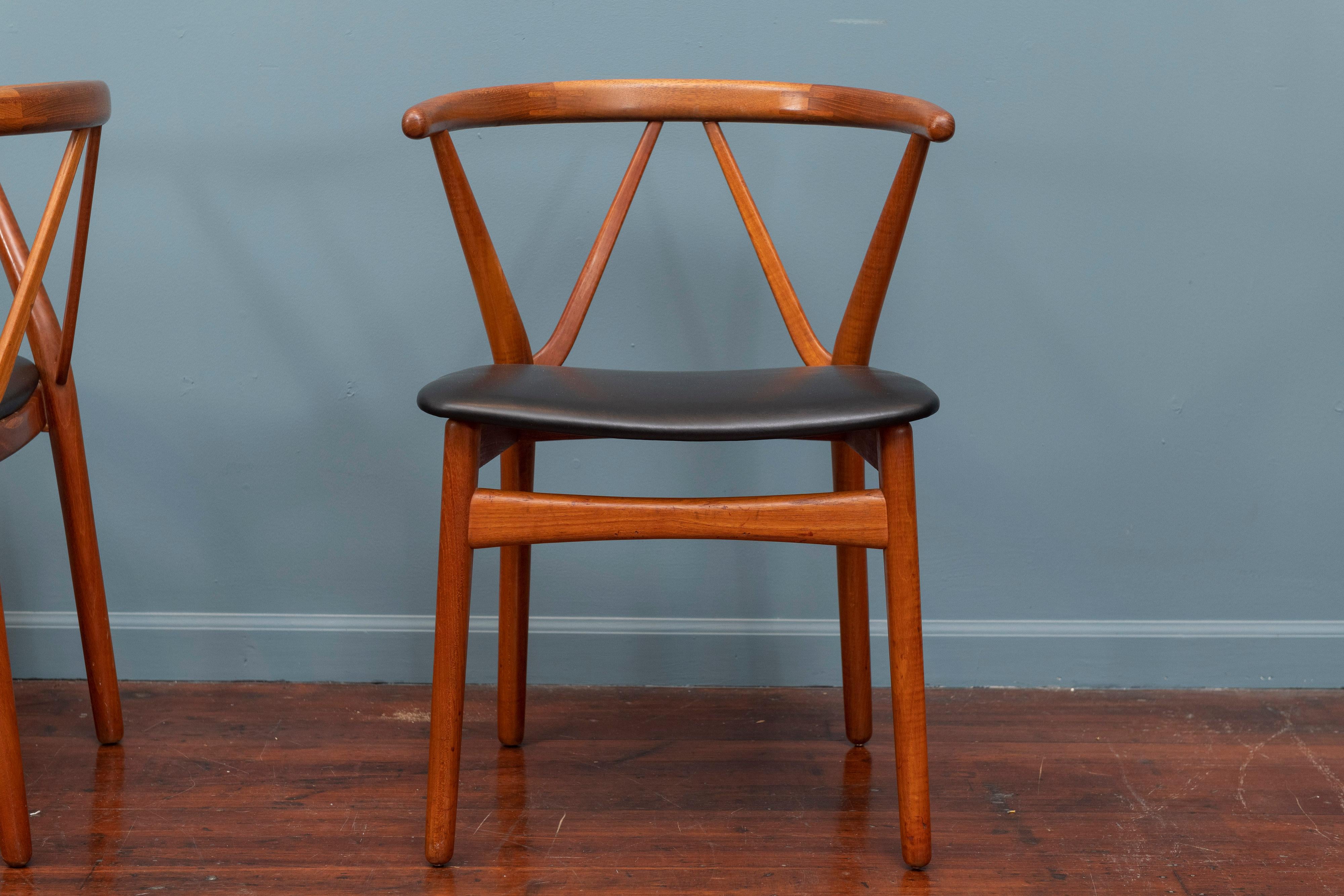Pair of Scandinavian Modern chairs deigned by Henning Kjaerhulf for Bruno Hansen, Denmark. Newly upholstered in black leather in very good vintage condition.