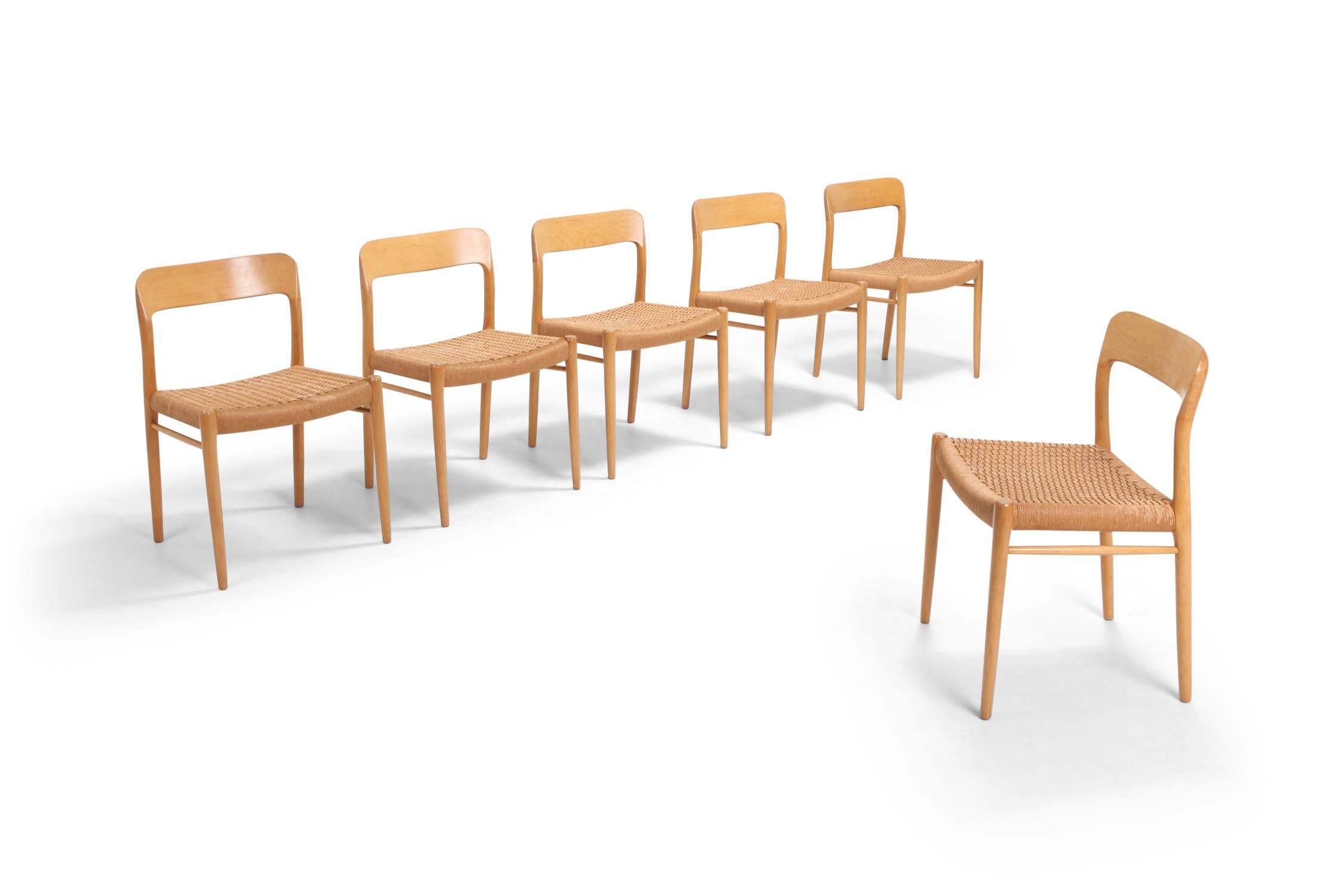 Model 75 chairs by Danish designer Niels Otto Møller, and manufactured by JL Møllers Møbelfabrik 
This is a rare edition in oak and with seating made of paper cord. 
Condition: The chairs are offered in excellent original condition with only minor