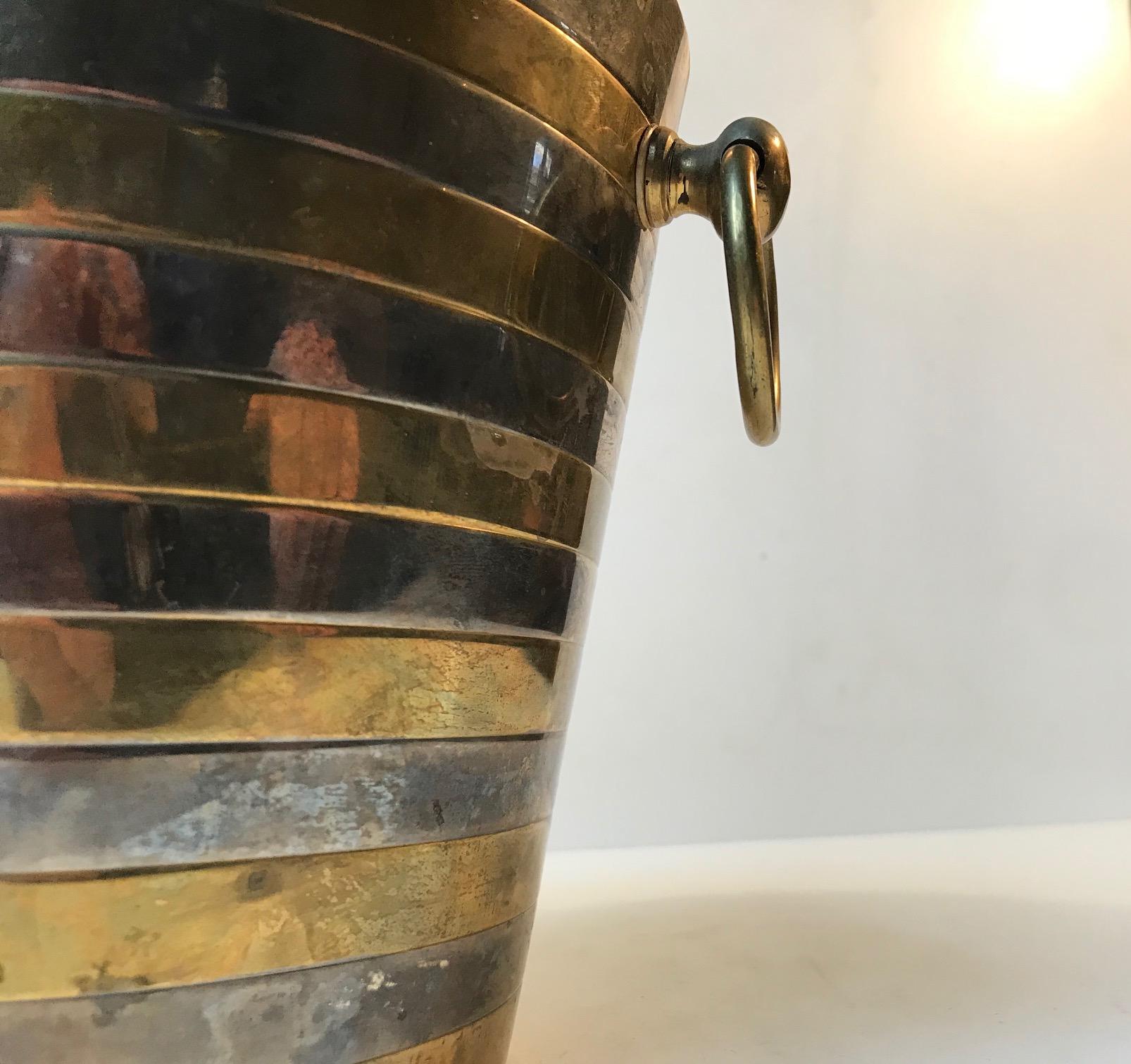 Stylish Champagne ice bucket fashioned out of brass and silver plated brass. It came from a Hotel in Göteborg, Sweden and was manufactured in Scandinavia during the 1950s or 1960s. The style of this piece is reminiscent of Georg Jensen. On request