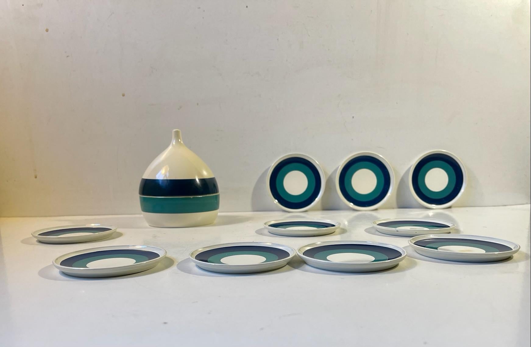 A set of painted resin coasters for drinks, coffee or tea. The set comes in its original onion shaped jar. Designed and manufactured by Laurids Lønborg in Denmark during the 1960s. The price is for all 10/11 pieces. Measurements: H: 10 cm, D: 8 cm