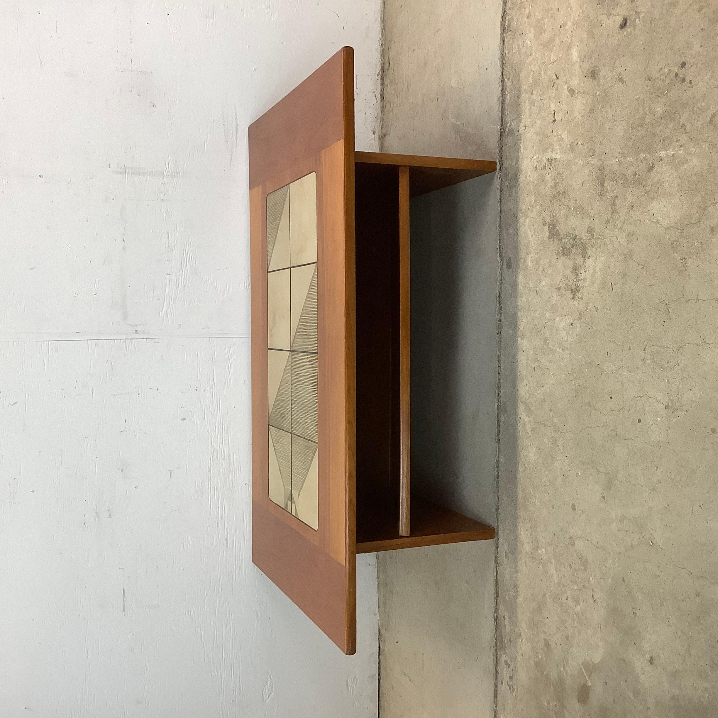 This vintage teak coffee table is a Danish modern classic, attributed to Gangso Mobler and featuring a stunning tile inlay top. Designed with both elegance and utility in mind, it brings a sophisticated yet relaxed charm to any space.

Crafted with