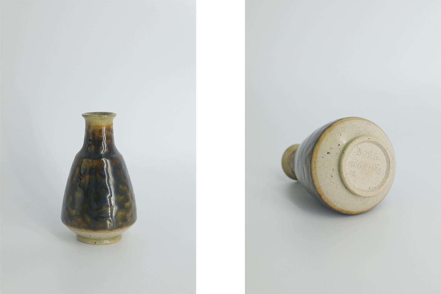 This miniature, collectible stoneware vase was designed by Gunnar Borg for the Swedish manufacture Höganäs Keramik during the 1960s. Handmade by a Master, with the utmost care and attention to details. The vase is colored brown and yellow, in an
