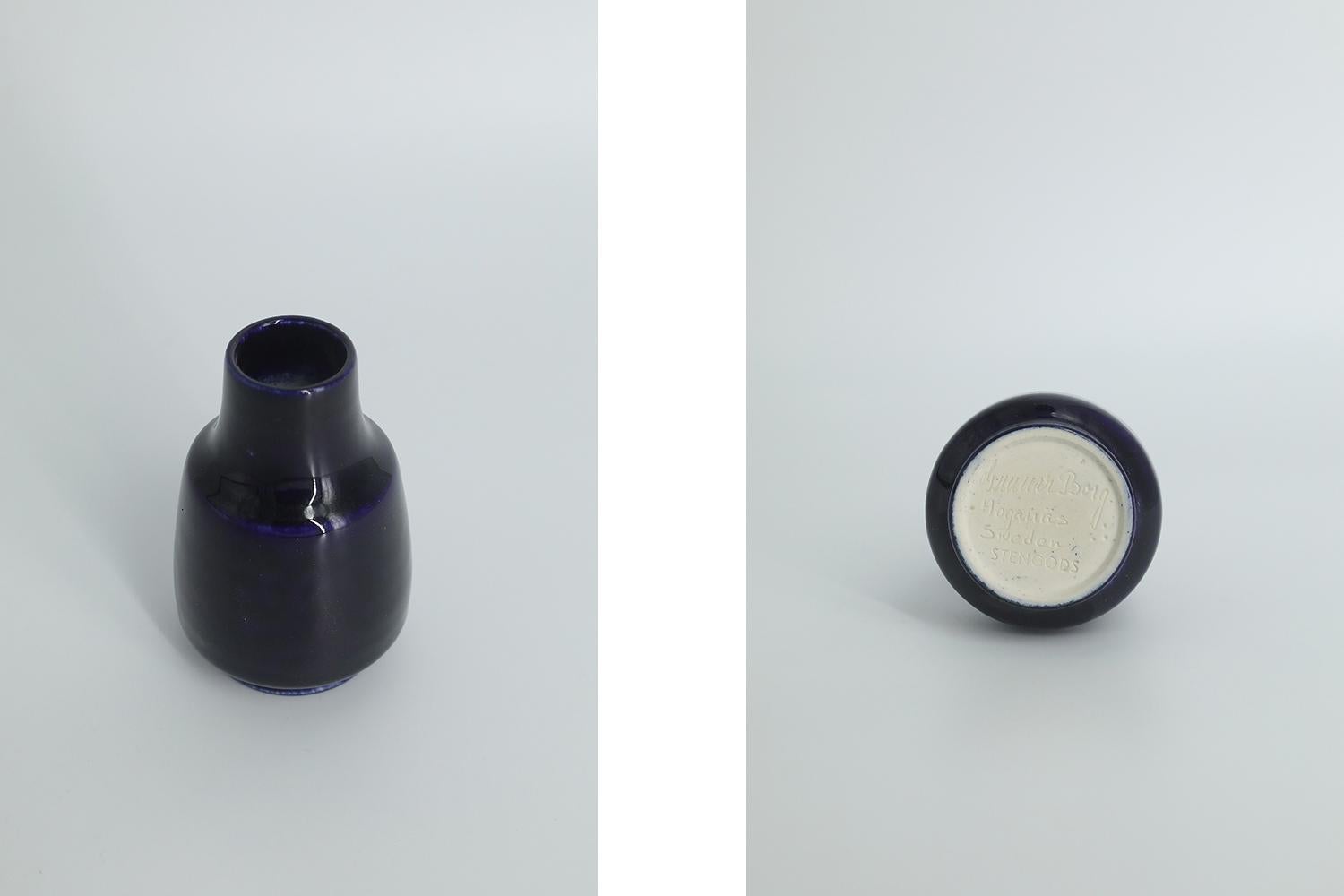 This miniature, collectible stoneware vase was designed by Gunnar Borg for the Swedish manufacture Höganäs Keramik during the 1960s. Handmade by a Master, with the utmost care and attention to details. This vase colored dark navy blue. Glazed.