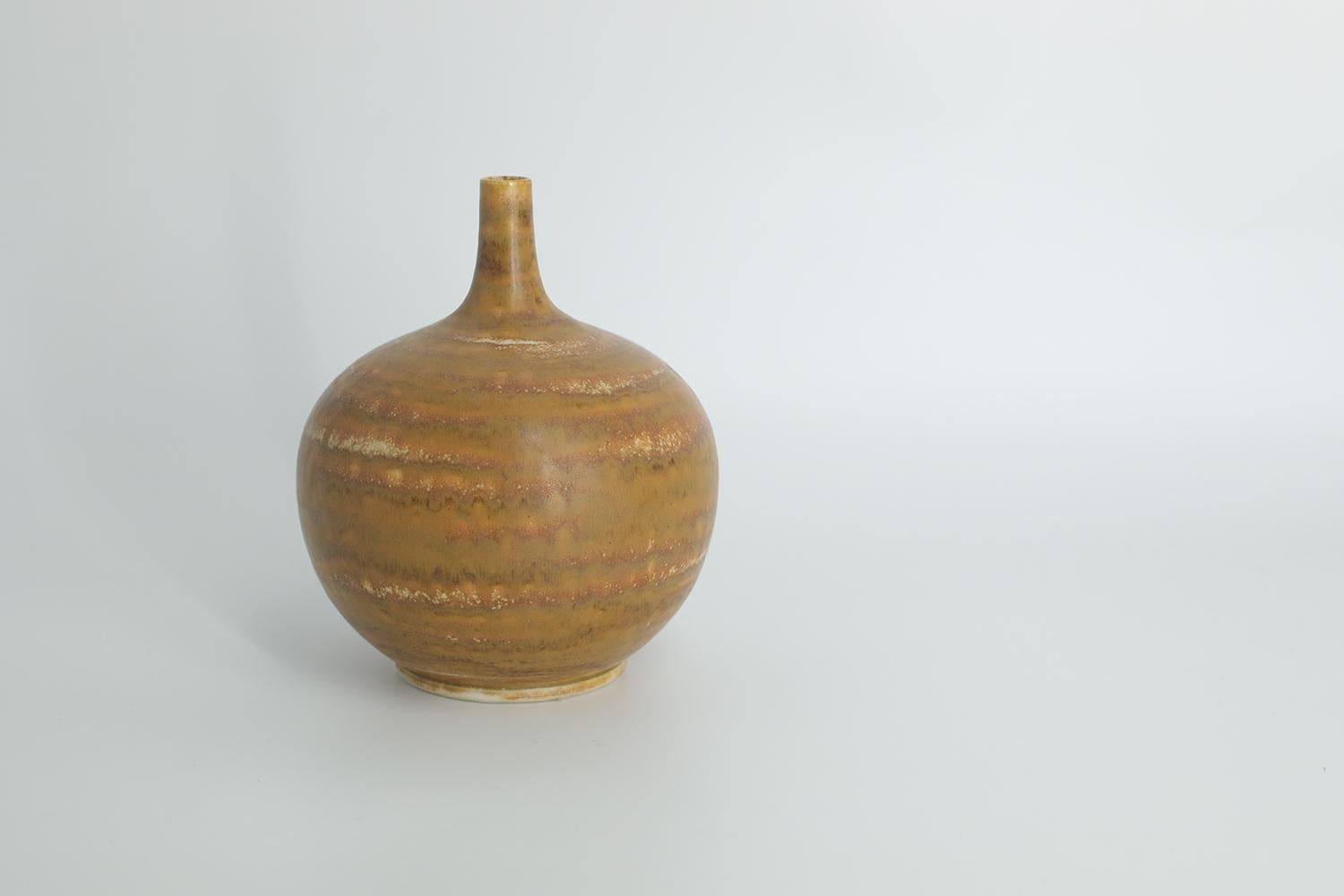This miniature, collectible stoneware vase was designed by Gunnar Borg for the Swedish manufacture Höganäs Keramik during the 1960s. Handmade by a Master, with the utmost care and attention to details. The vase has the shape of a ball and is colored