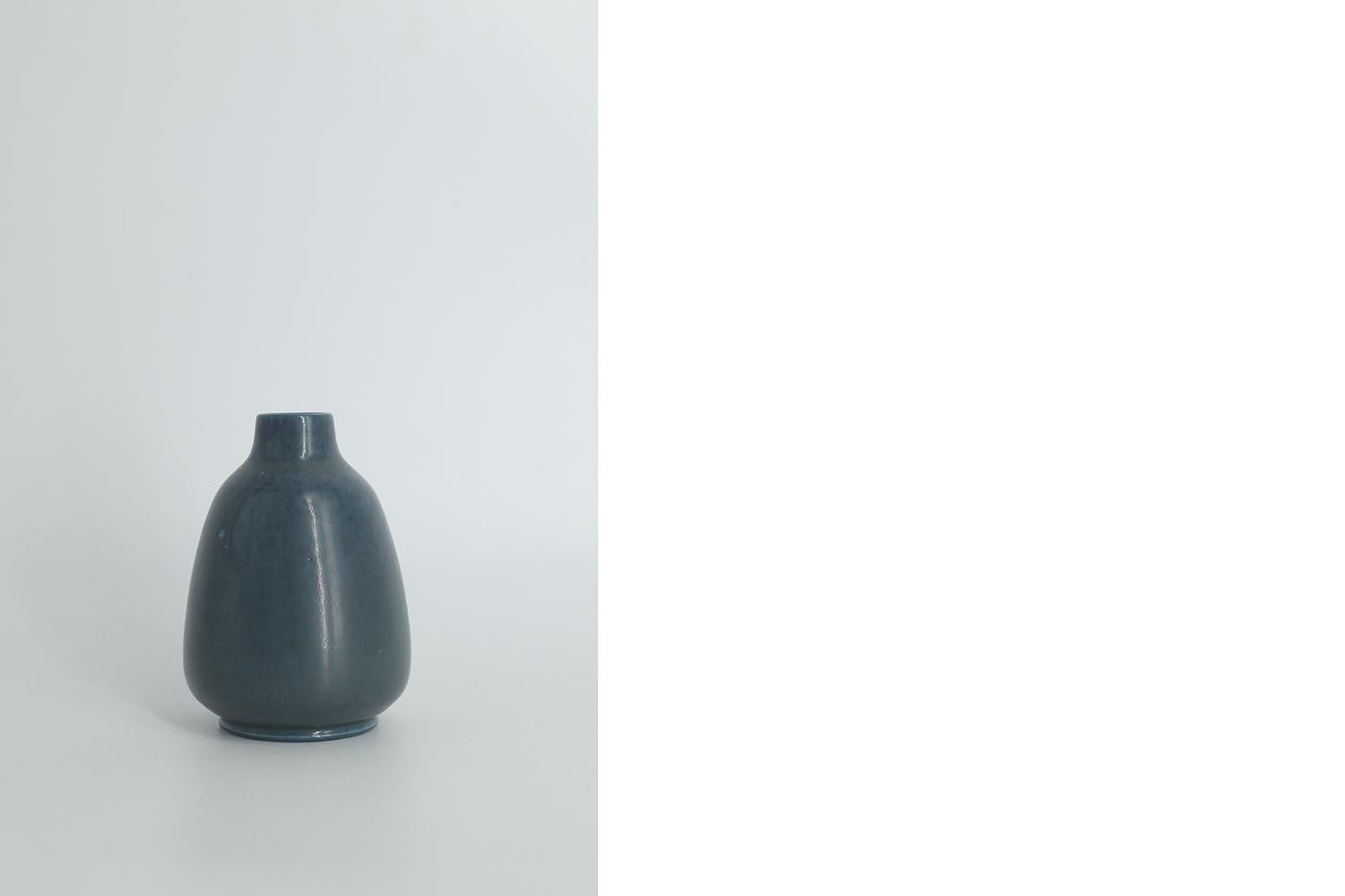 This miniature, collectible stoneware vase was designed by Gunnar Borg for the Swedish manufacture Höganäs Keramik during the 1960s. Handmade by a Master, with the utmost care and attention to details. This vase dyed a deep sea color in an irregular