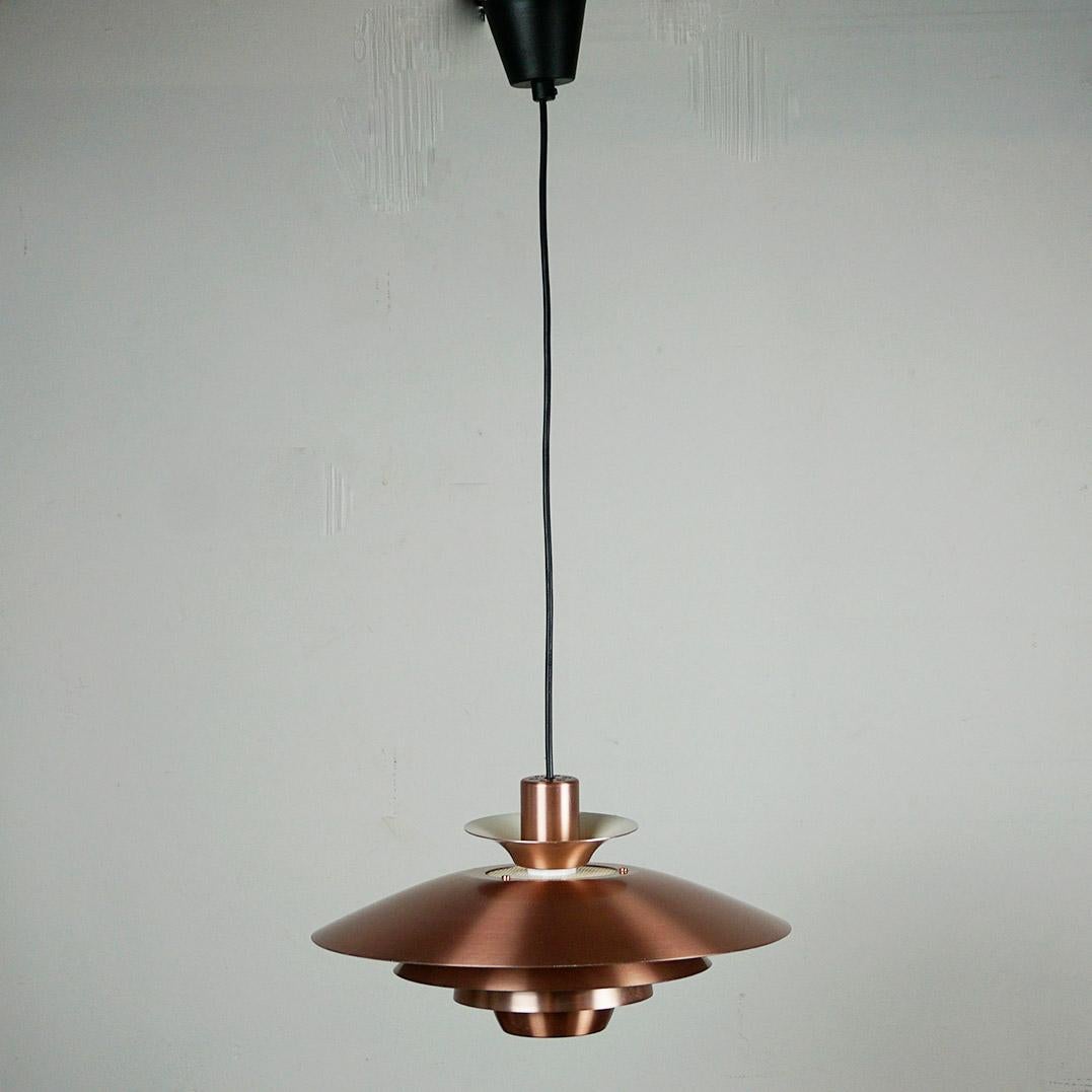 This charming copper coloured Scandinavian Modern pendant was designed and produced in the 1960s in Denmark by Jeka, Model Alexia. You can find the original label inside.
 Its design is in tradition and very close to lamps by Jo Hammerborg, main
