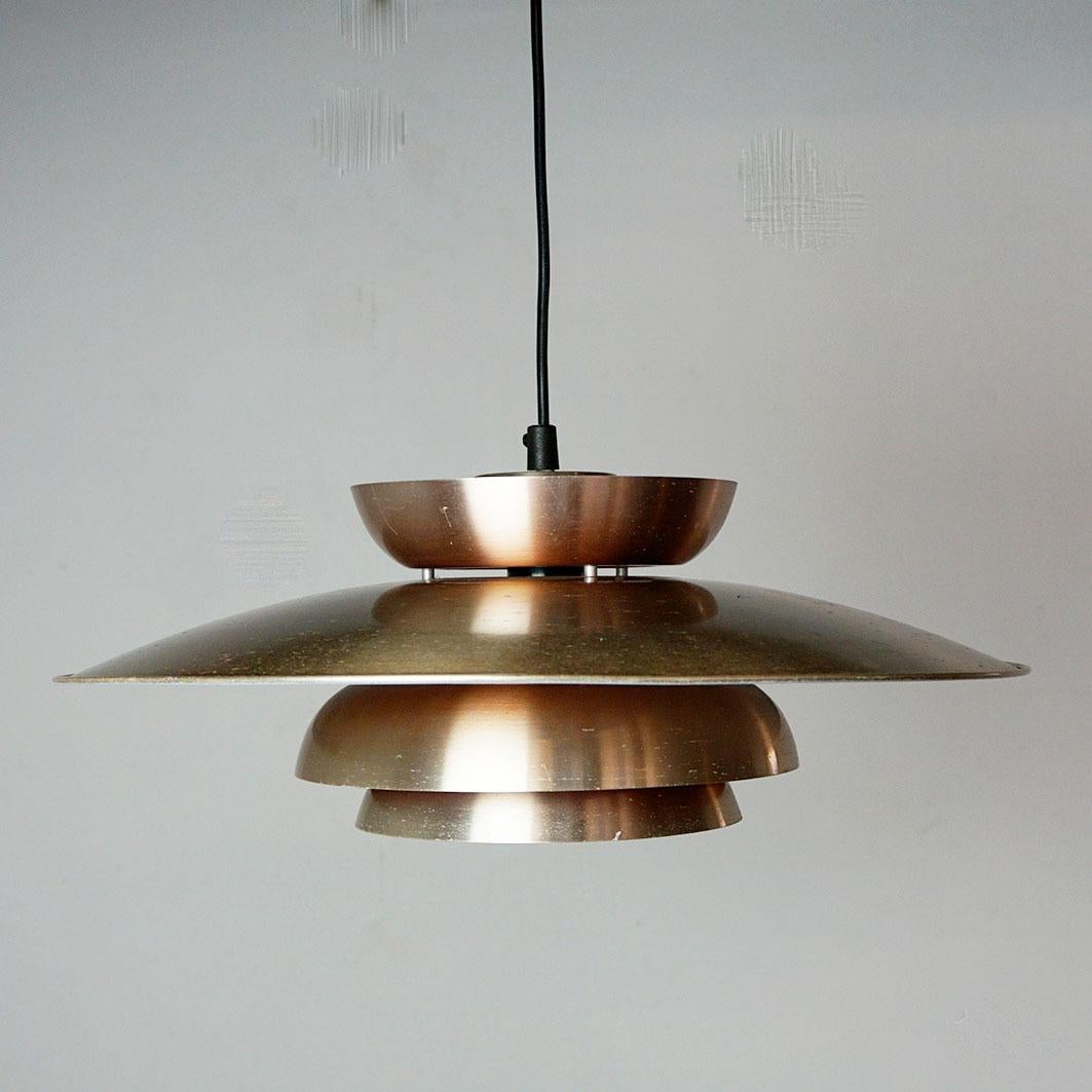 This charming copper coloured pendant was designed and produced in the 1980s in Denmark and its design is in tradition and very close to lamps by Jo Hammerborg, main designer of Danish lighting manufacturer Fog & Mørup in the 1960s and 1970s. On the