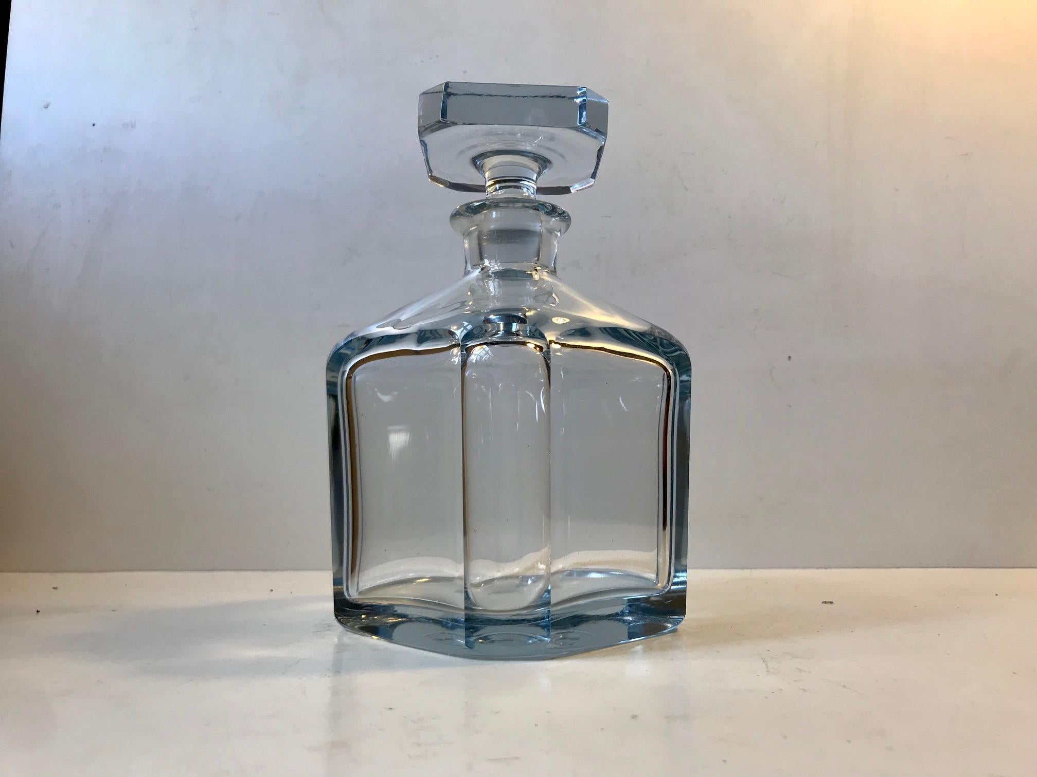 Heavy Strömbergshyttan crystal decanter. Crafted of thick crystal with it's characteristic light blue hue. Superb fro storing your beloved Cognac or Whiskey. Capacity approx. 0.7 liter. The bottom signed in script Strombergshyttan and the design