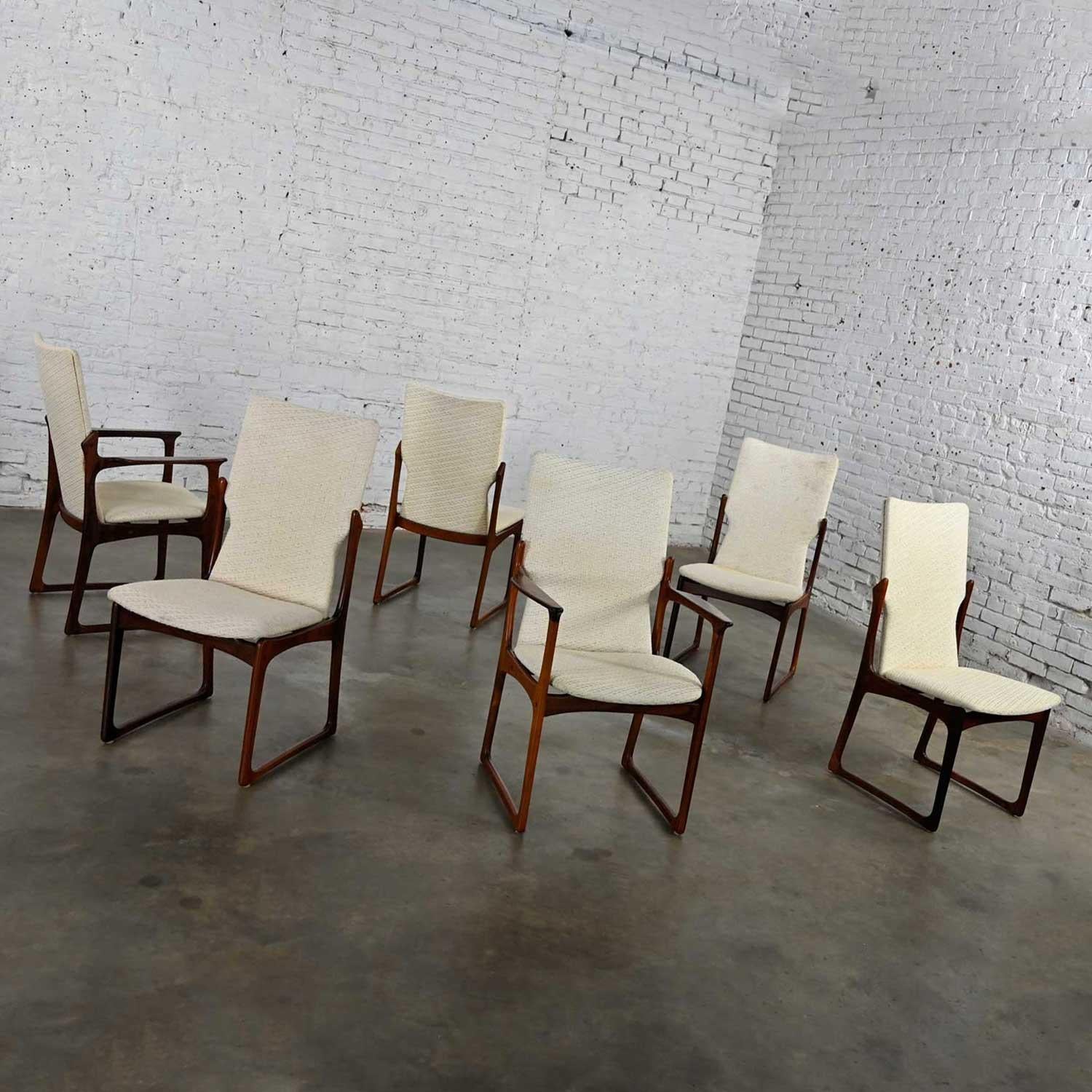 Fabulous Scandinavian modern Danish rosewood dining chairs by Art Furn including 4 side and 2 armchairs, set of 6. Comprised of solid rosewood and a nubby off-white fabric upholstery that show signs of the original fabric underneath. They have all