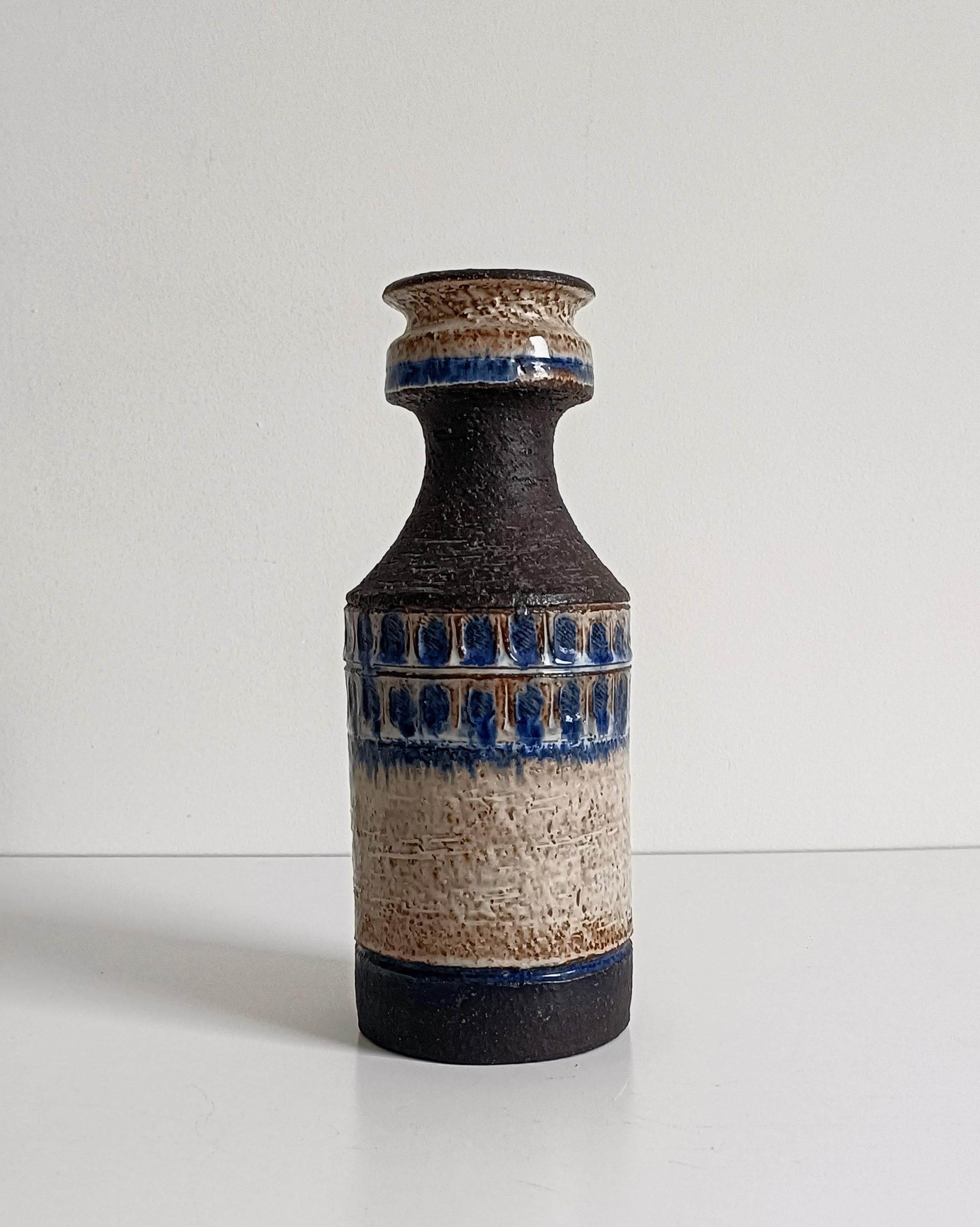 Scandinavian Modern Chamotte Vase
Handmade in Denmark, circa mid-20th century

A visually arresting Scandinavian Modern vase, hand-formed in heavily textured chamotte clay. The rough, dark brown surface is contrasted by a wide band of earthy cream
