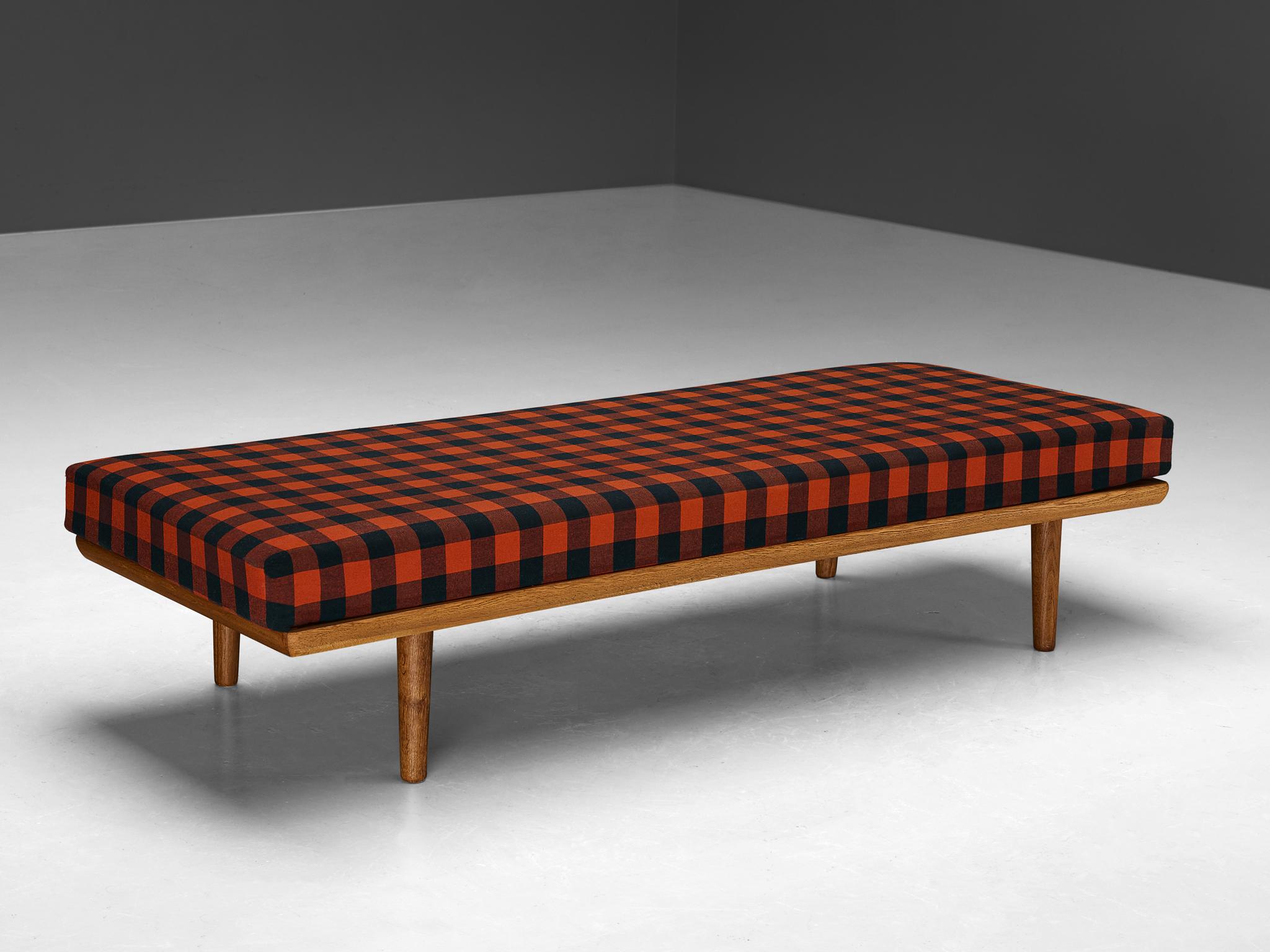 Daybed, oak, pine, Scandinavia, 1960s

A simple and minimalist bed manufactured in Scandinavia in the 1960s. A standout fact about this piece is the mattress that is upholstered in a red and black checkered fabric. The construction is based on clear