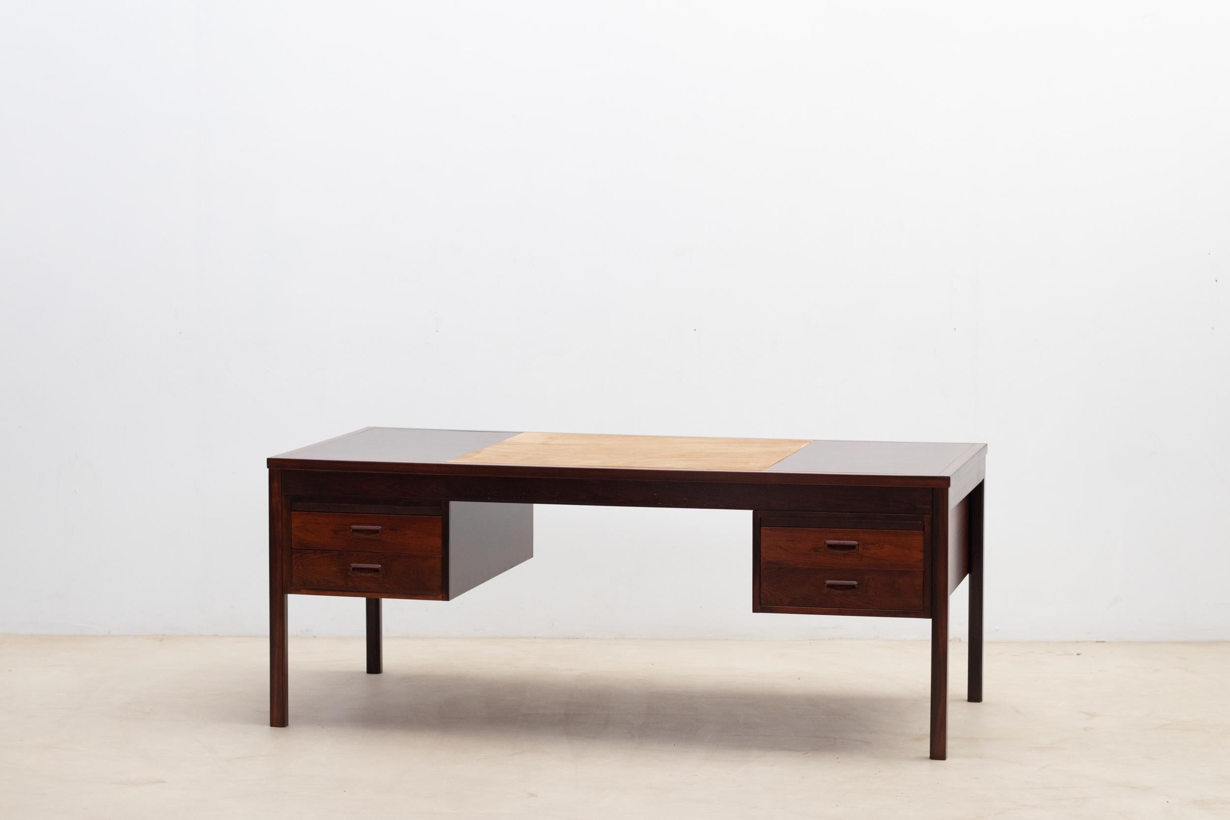 Scandinavian rosewood desk dating back to 1960, showcasing a minimalist design with straight lines. 
On the top, the workspace is covered with leather.
Very good condition.

Do not hesitate to contact us for any additional information. We would be