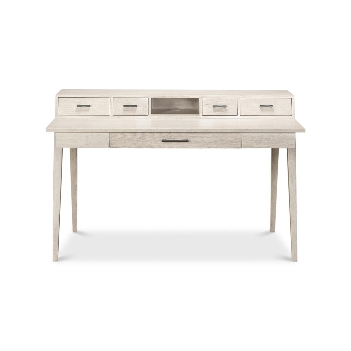 Scandinavian Modern Desk, an ivory finish to this modern writing table that has an angled superstructure with drawers above a rectangular writing surface and with one long frieze drawer and raised on angled square tapered legs.

Dimensions: 54