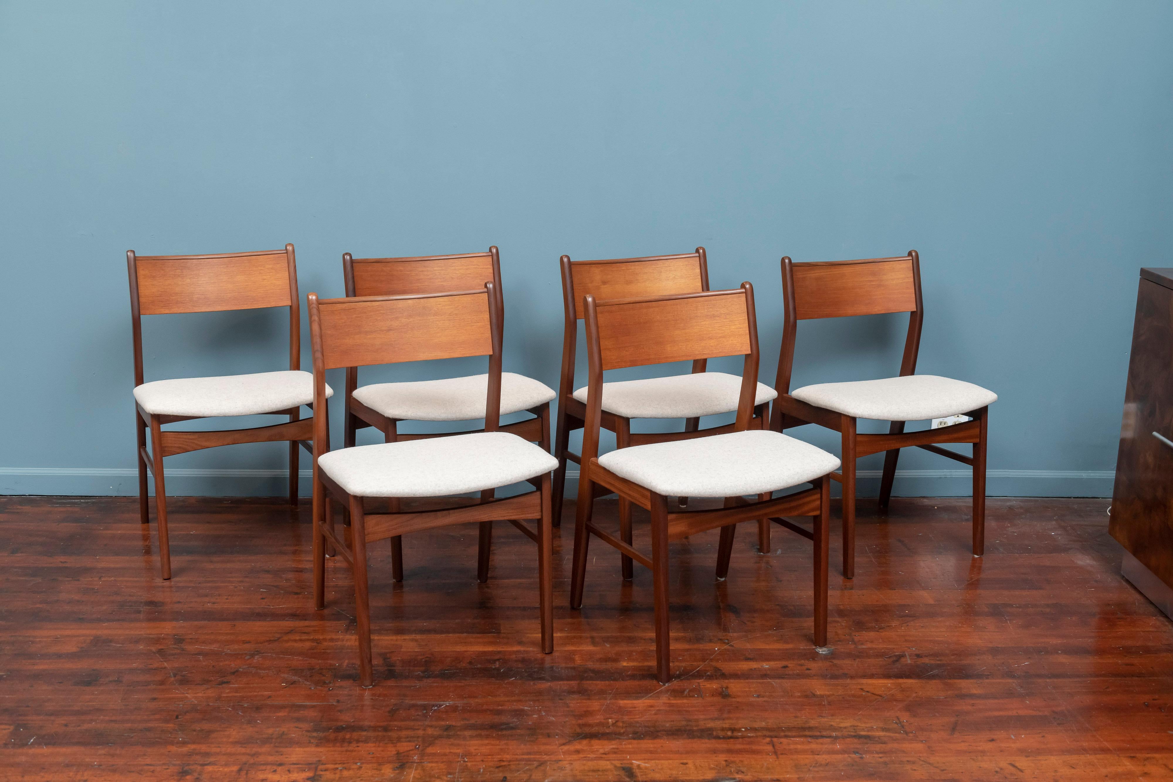 Scandinavian Modern set of six teak dining chairs with newly upholstered Maharam felt seats.