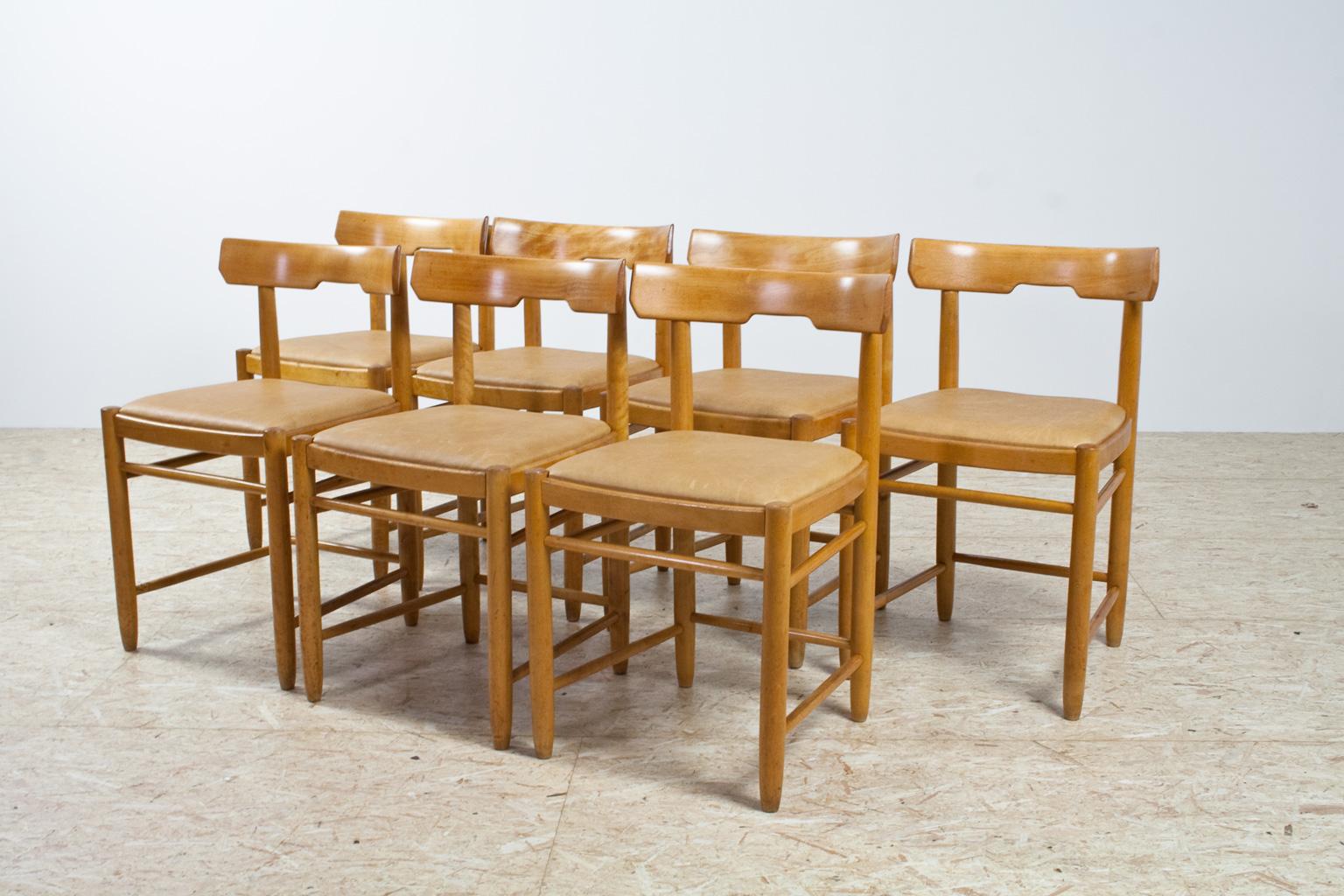 Scandinavian Modern re-upholstered set of 7 Beech dining chairs, Danish origin possibly Farstrup. Construction of the frames are checked, restored and oiled, pieces are re-upholstered with a camel/ tan colored natural leather. In great condition.