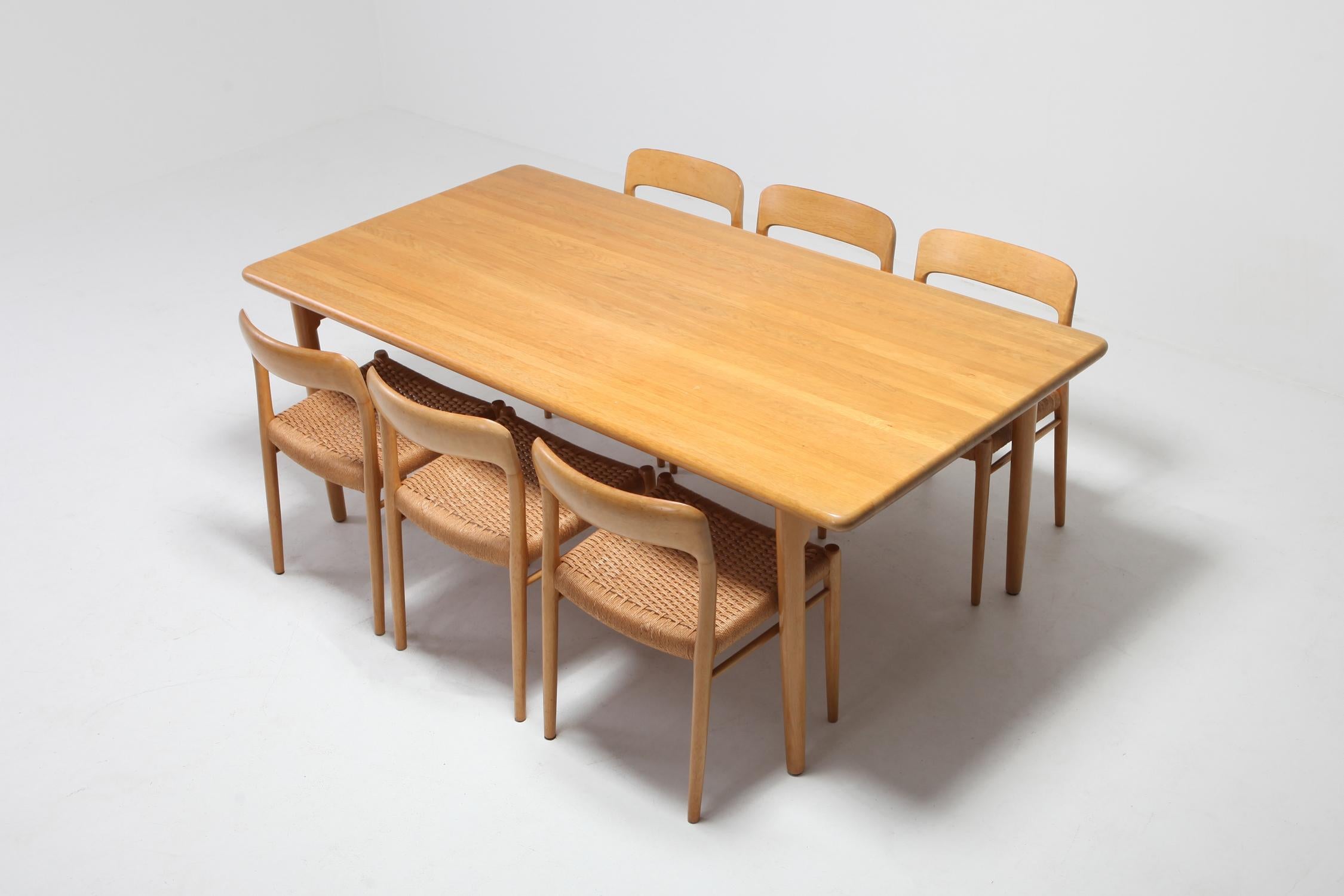 Dining table and chairs by Danish designer Niels Otto Møller, and manufactured by JL Møllers Møbelfabrik 
This is a rare edition in oak and with seating made of paper cord. 
Condition: The chairs are offered in excellent original condition with