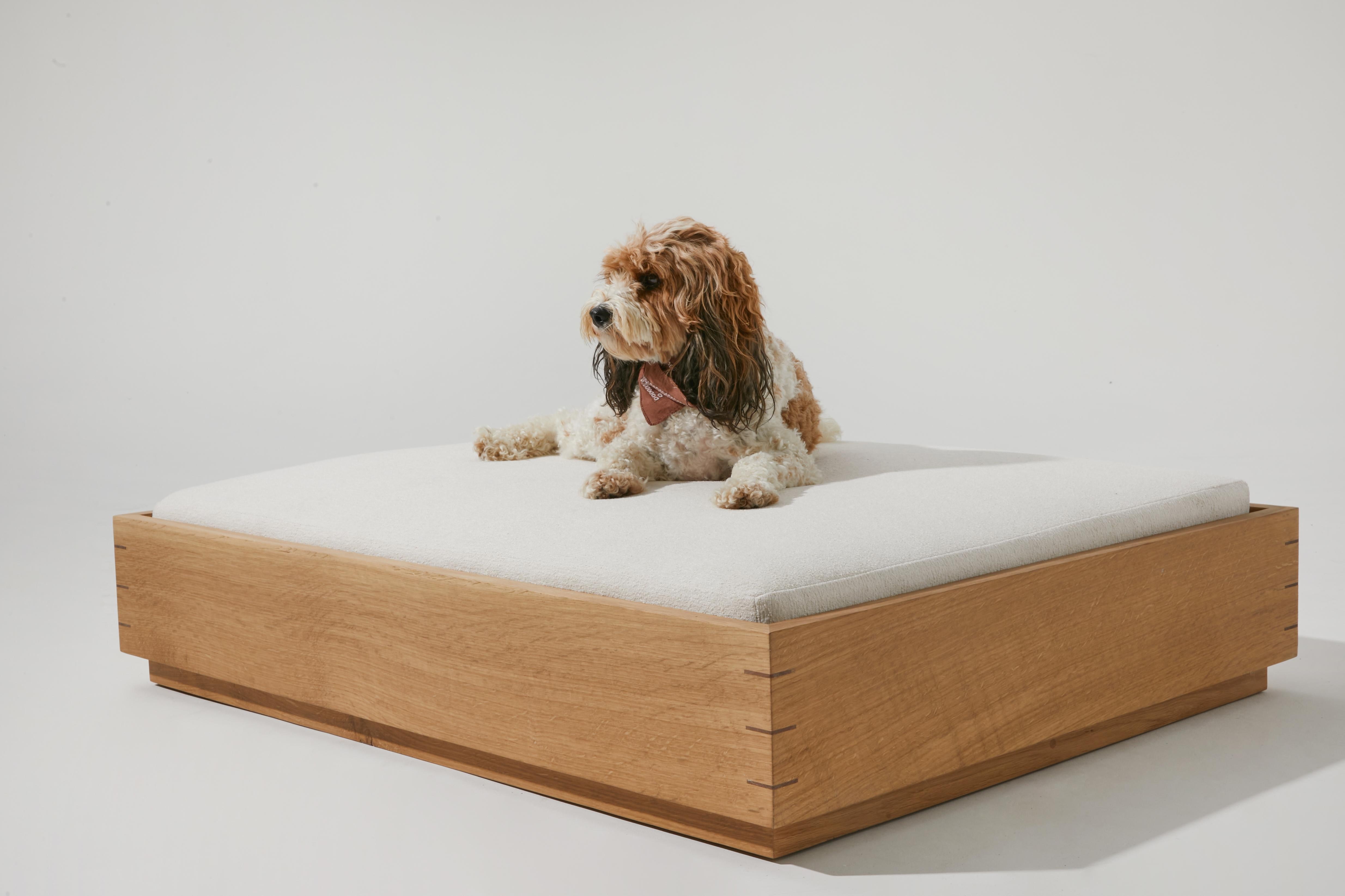 The Good Bed is named after and inspired by my two golden retrievers and their uncanny ability to sleep all day and all night. Made from quarter sawn white oak with mitered corners reinforced with walnut splines. It comes with a removable washable