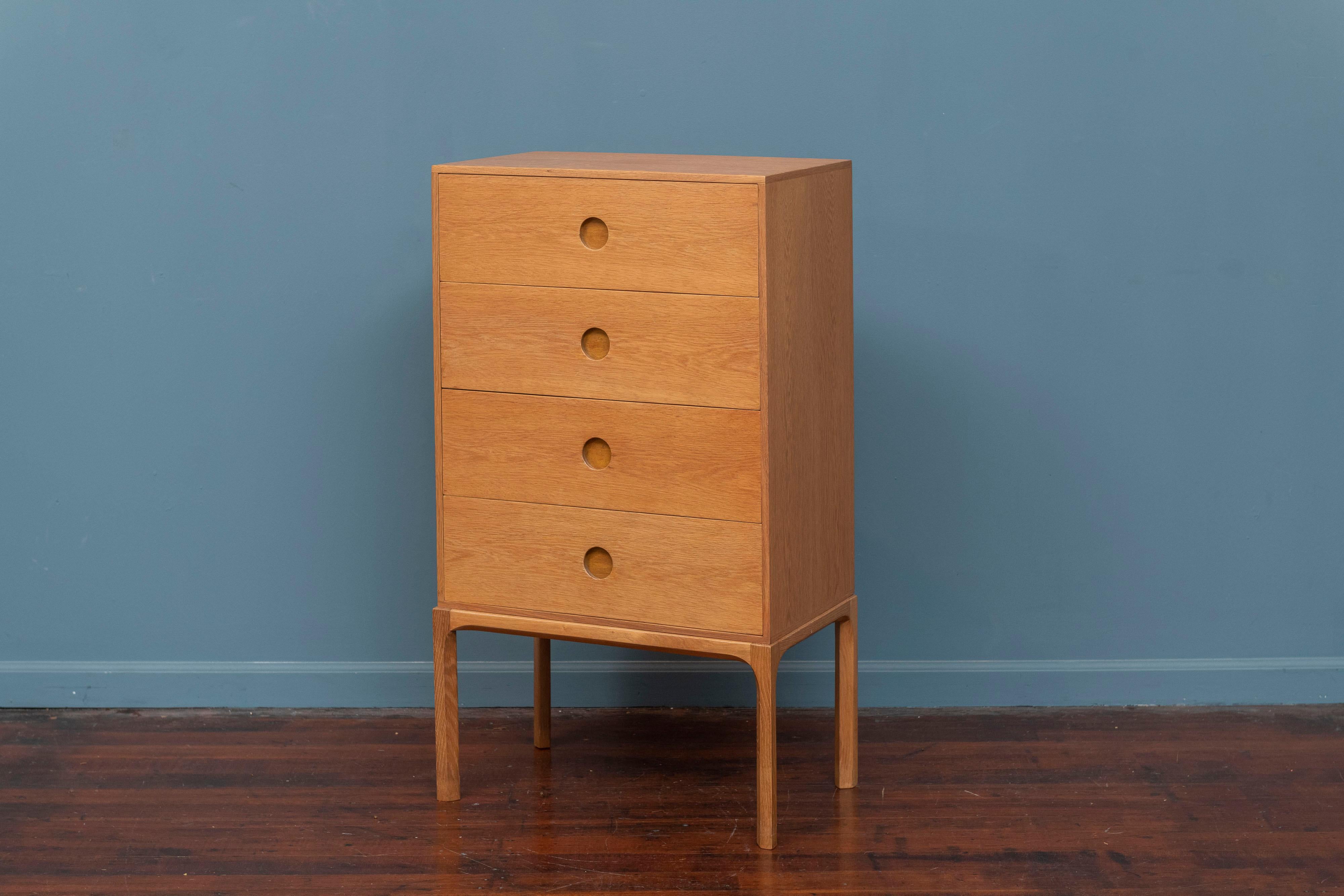 Scandinavian Modern four drawer chest designed by Kai Kristiansen for Askel Kjaersgaard, Model 835. Made from the high quality solid teak with attention to detail, sculpted edges, circlular drawer pulls and dove tail constructed drawers. 
A very