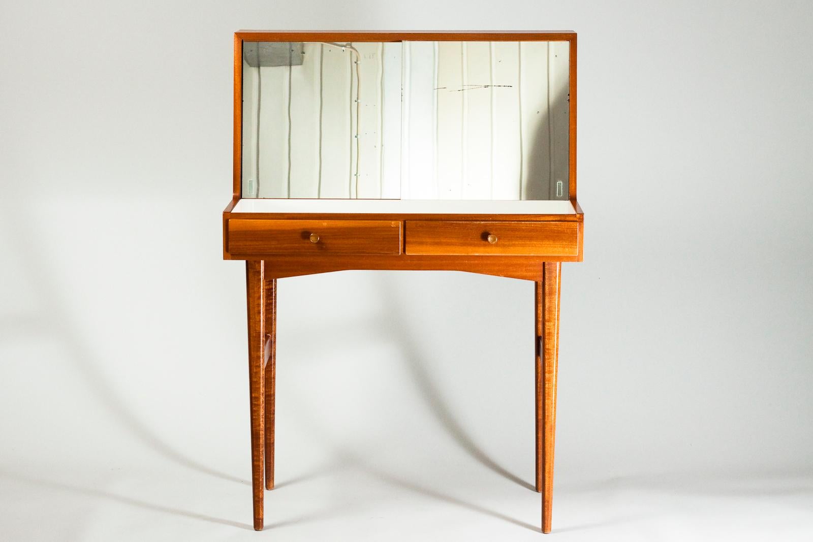 Rare Mid-Century Modern Finnish dressing table designed by Olof Ottelin for Oy Stockmann Ab in the 1950s. The condition is very good and only some scratches in the mirror can be found. In the Drawer there is a special compartment for make-up. Behind