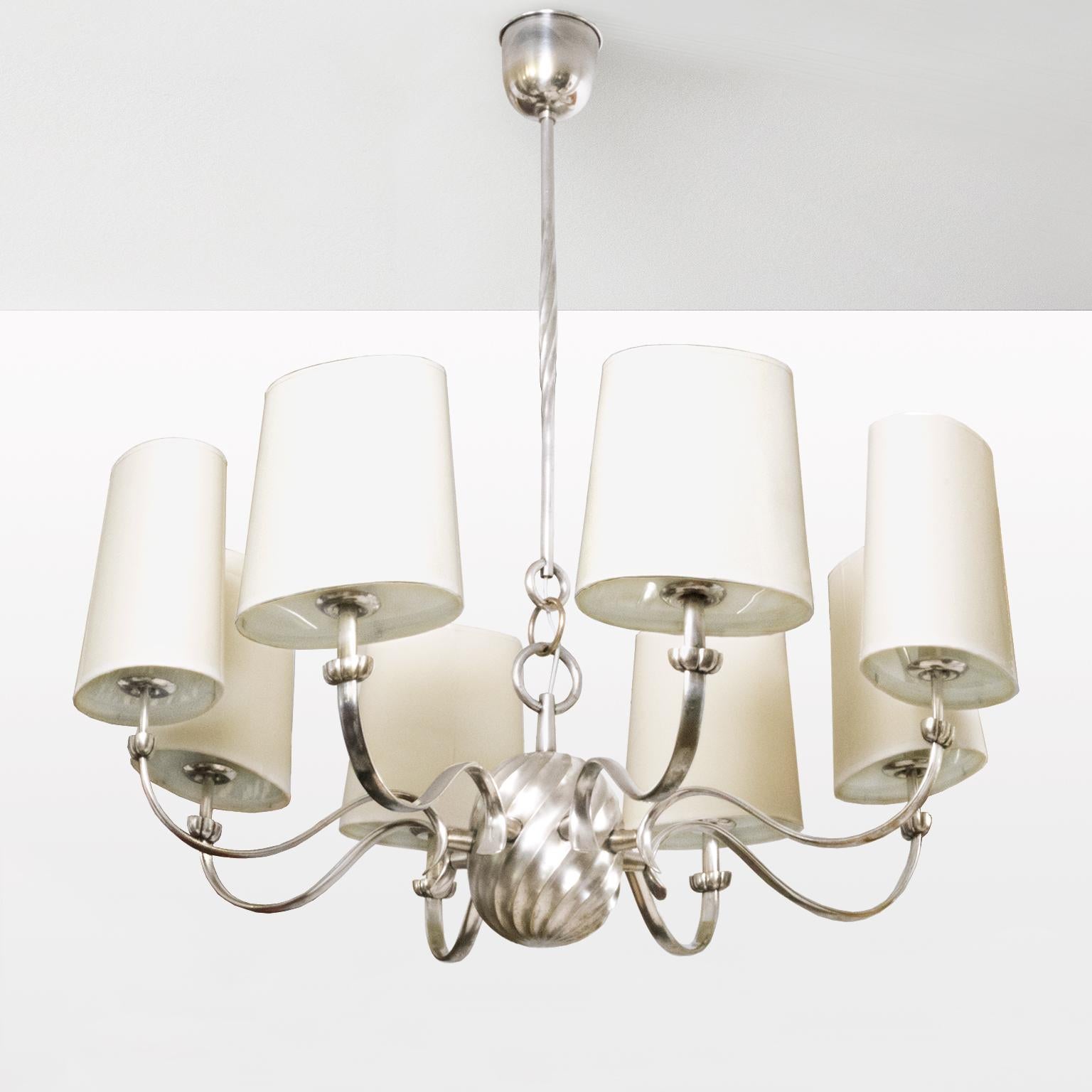 Scandinavian modern eight-arm silver plated bronze chandelier with twisted centre sphere and curved ribbon form arms. Newly restored, polished and lacquered with new wiring ready for use in the USA. Each arm has a standard base socket, a newly