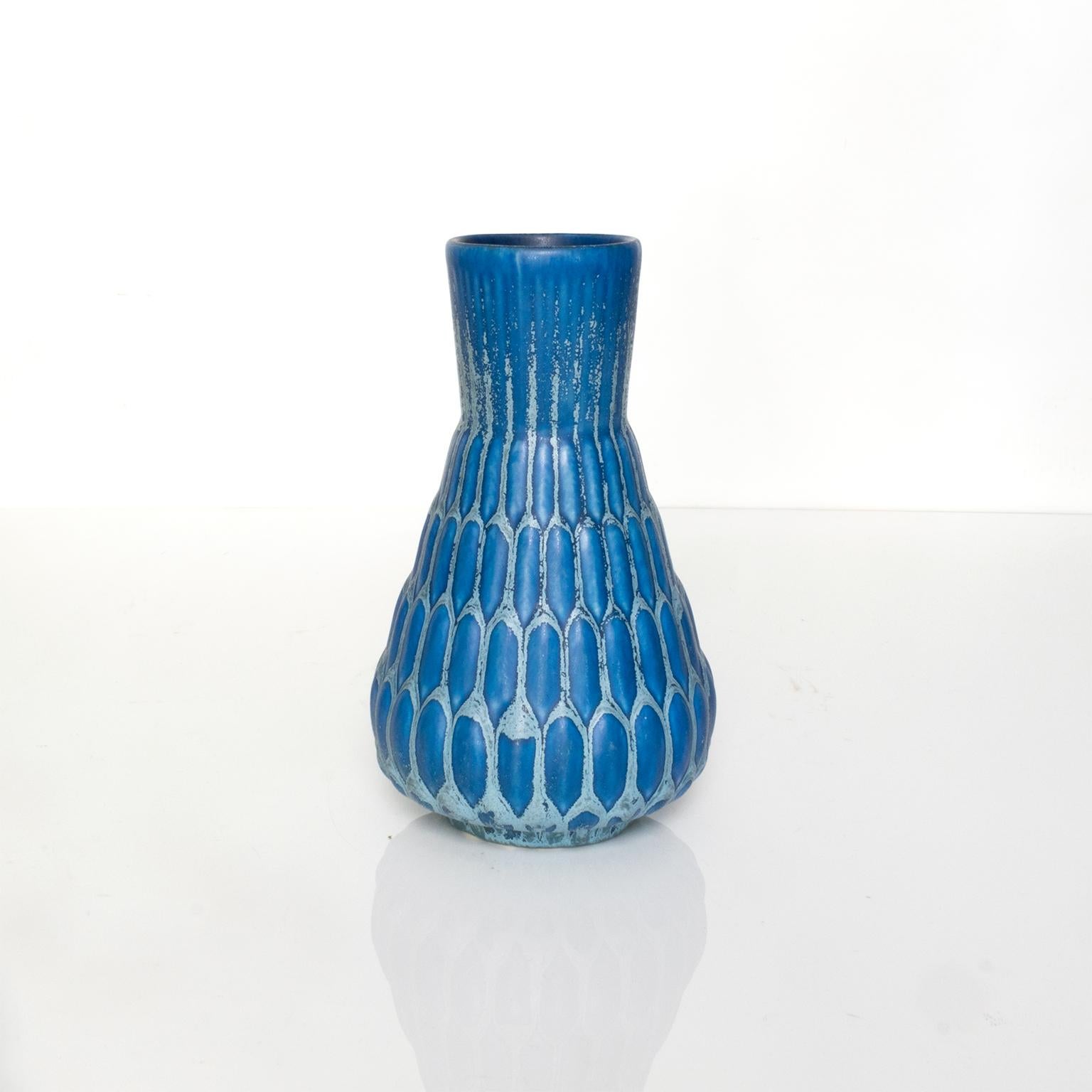 Ewald Dahlskog ceramic vase in blue glaze over a tapered form with a pod like pattern. Made at Bo Fajans, Sweden, circa 1940.

Measures: Height 8.25“, diameter 4.5“.