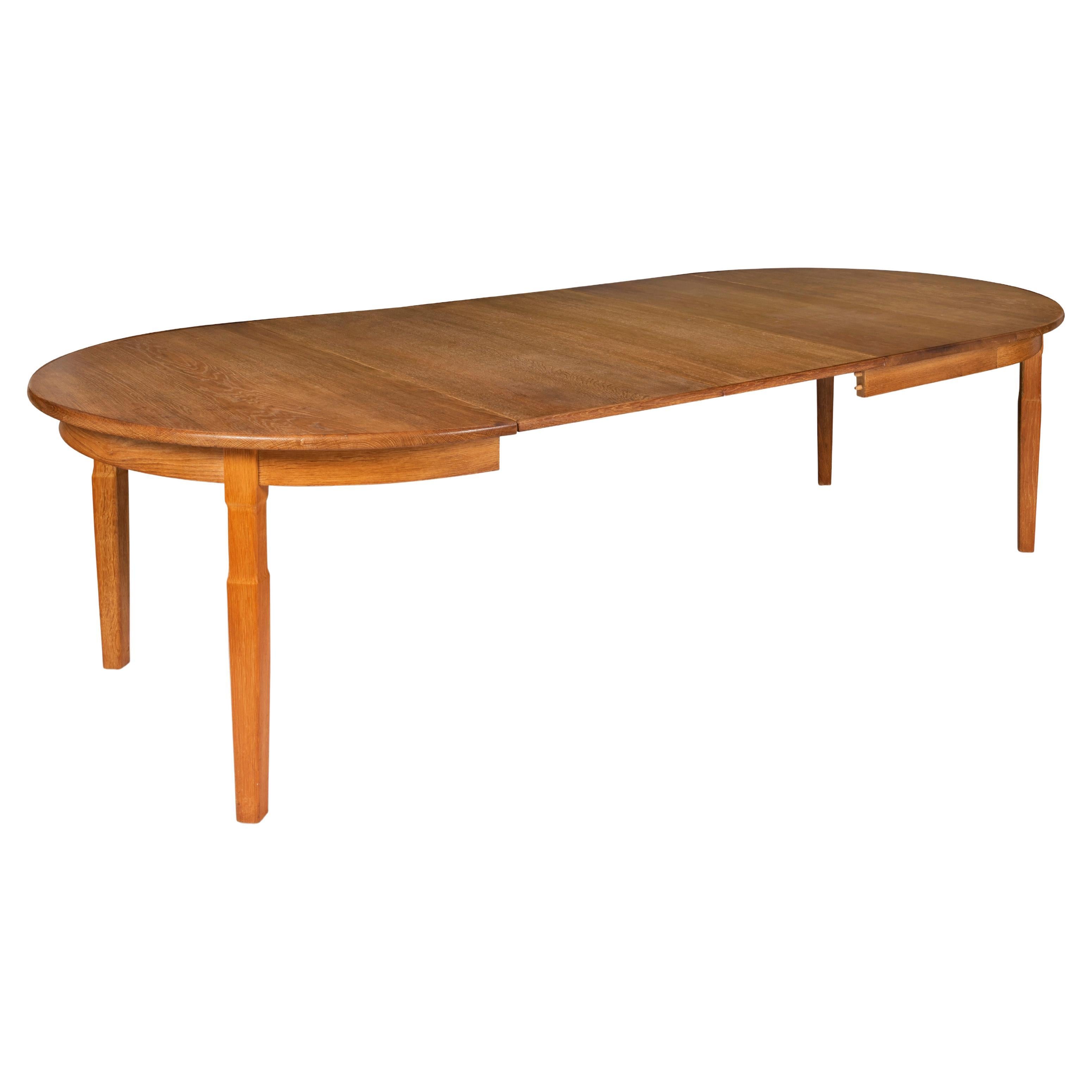  Scandinavian Modern Extendable Oval Oak Dining Table by Henning Kjaernulf For Sale