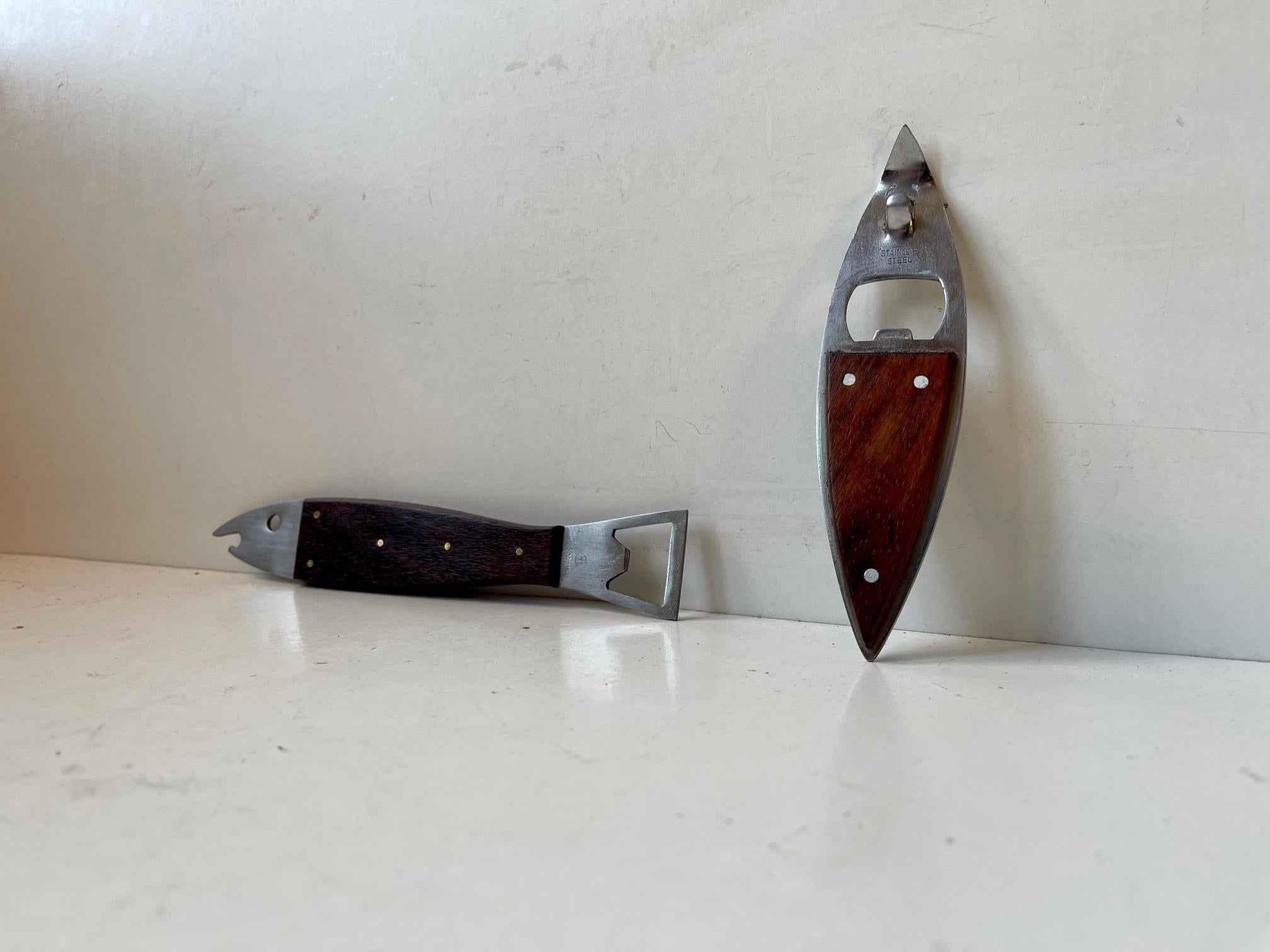 A set of bottle openers designed and manufactured in Denmark/Scandinavia in a style reminiscent of Carl Auböck. Both of them are made from dark wood and stainless steel. Measurements: L/H: 20/15 cm.