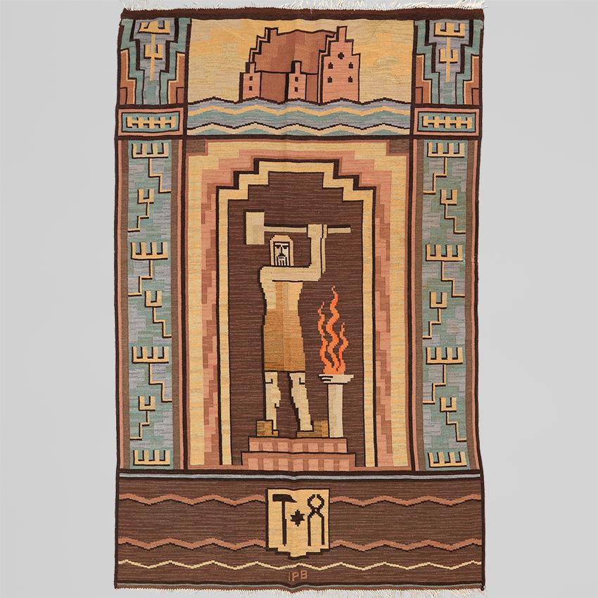 A very special Scandinavian Modern flat-weave rug or wall hanging from circa 1920s. The rug features highly stylized imagery including a blacksmith standing between columns with a hammer and fire. The panel above has a castle (slott) with a body of
