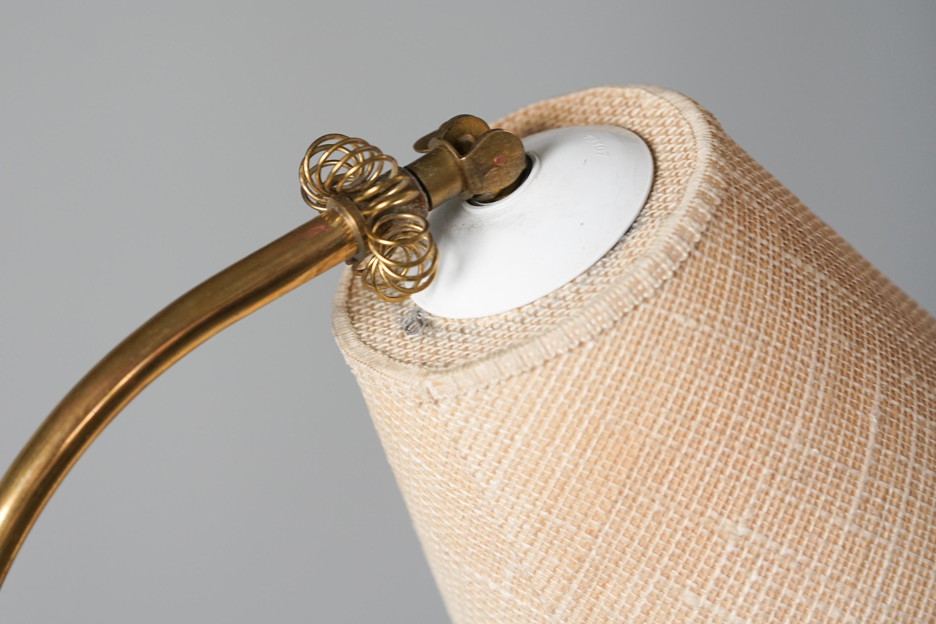 Scandinavian Modern Floor Lamp, manufactured in Finalnd, 1950s. Brass frame, fabric shade. The shade is reversible. Good vintage condition, minor patina consistent with age and use. 
