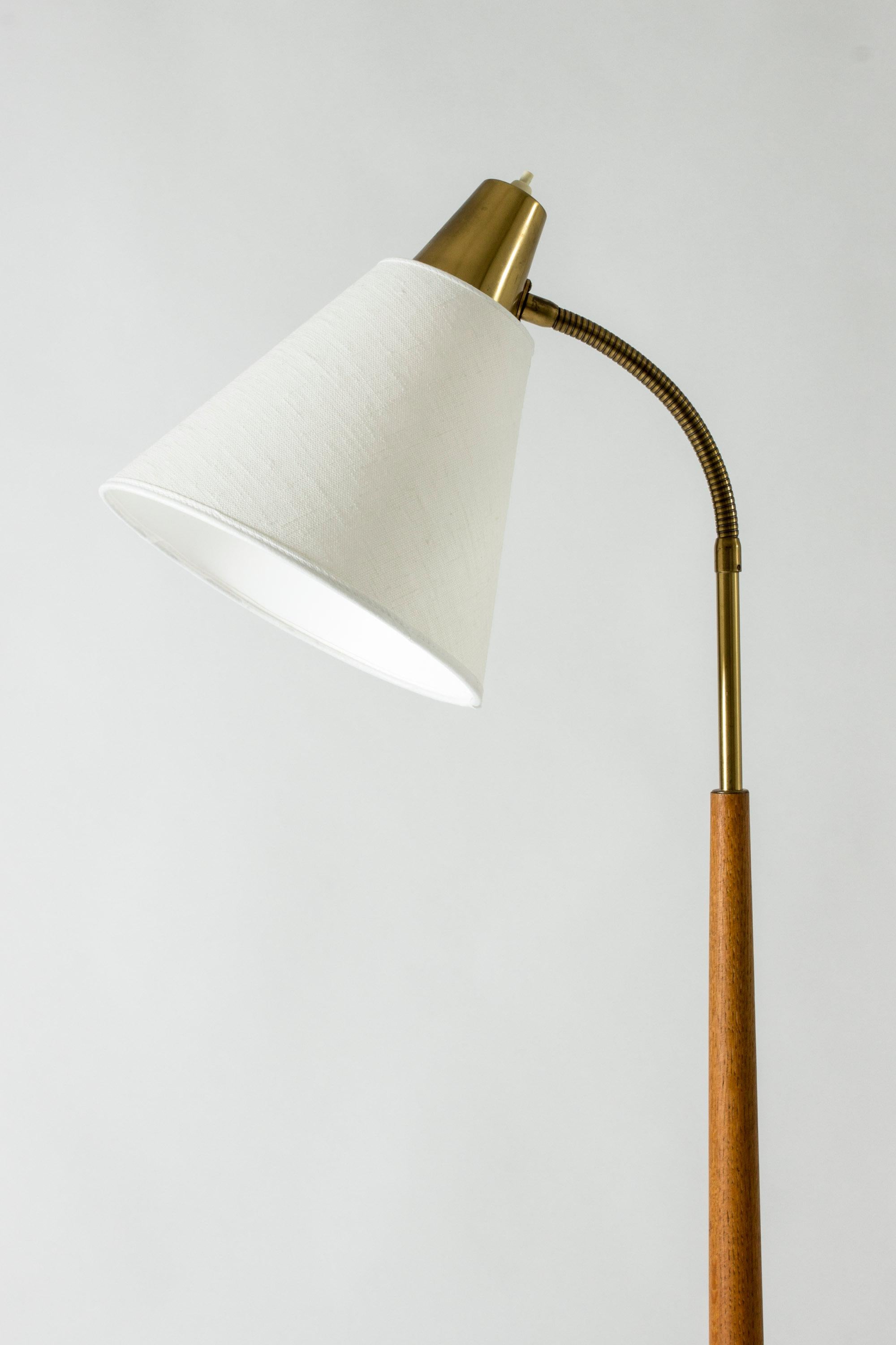 Brass floor lamp from Falkenbergs Belysning, with an elegant wooden stem and flexible neck.