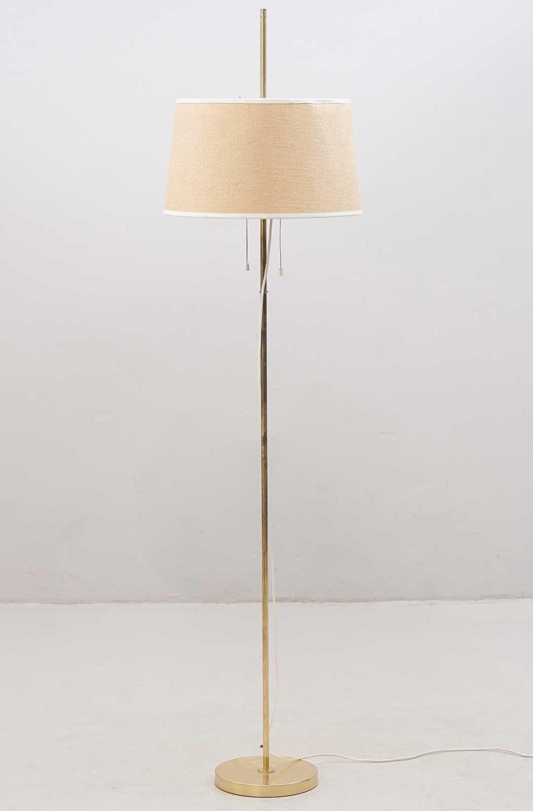 The floor lamp is made of brass, original lampshade with 2 lamp holders. The lampshade is adjustable in height.  

 
DIMENSIONS:  
Height: 162 cm 
Diameter lampshade: 41 cm 
 