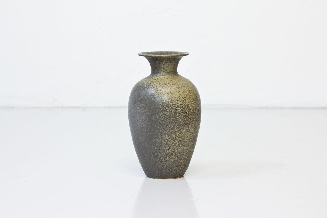 Tall stoneware vase handmade in Sweden during the 1960s. 
Taupe color speckled beige glaze. 
Signed by unknown maker on the bottom.