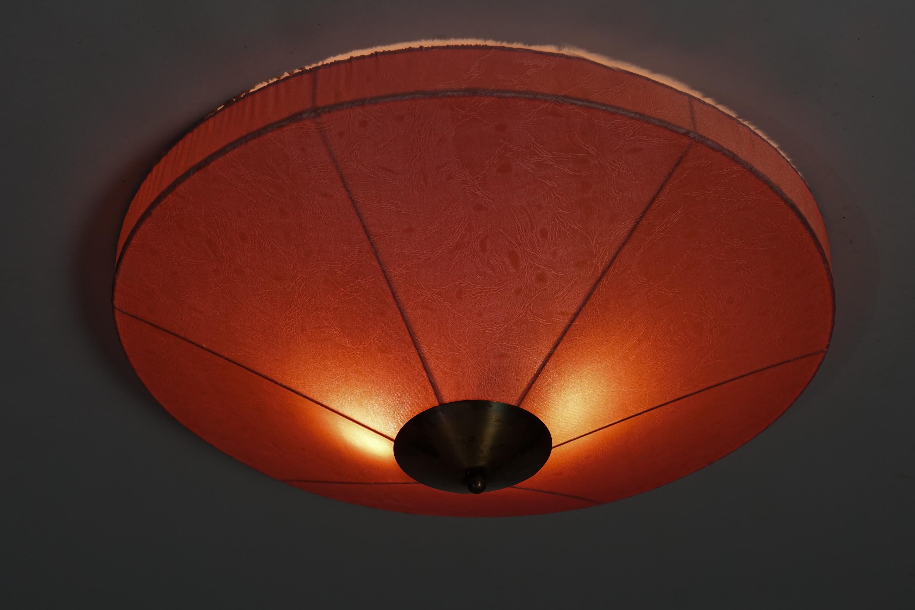 Scandinavian Modern flush mount, manufactured in Finland, 1950s. Fabric lampshade with brass details. Good vintage condition, patina and minor wear consistent with age and use. Beautiful and delicate Scandinavian Modern design. 