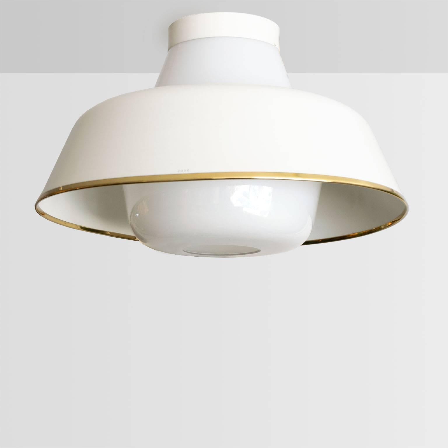 Scandinavian modern flush mount fixture made of lacquered metal trimmed with polished brass and opal glass. This fixture has one Edison standard base socket (newly rewired for the USA). Made by Orno Oy for Stockmans, Helsinki, Finland