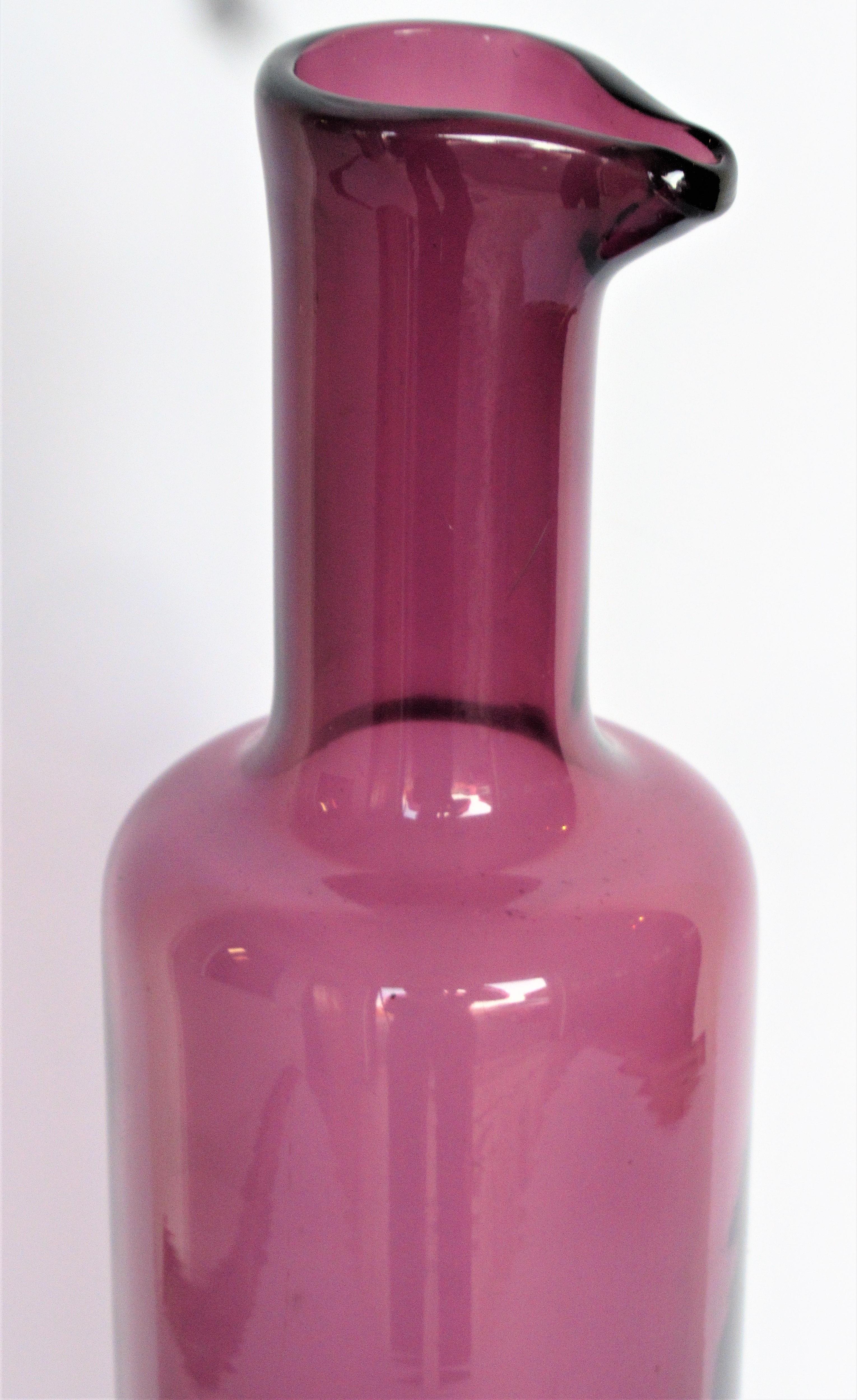 Handmade glass bottle by Nanny Still, Finland (1926-2009) The color of this bottle is called old rose. Diamond cut signed on underside bottom, Riihimaen Lasi Oy Nanny Still, Circa 1950s. Beautiful. Look at all pictures and read condition report in