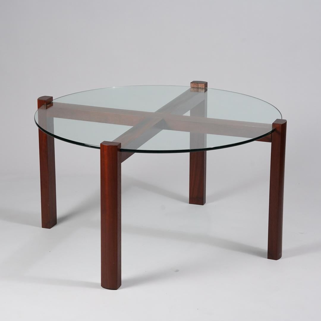 Scandinavian Modern coffee table, 1980s/1990s. Mahogany frame with glass table top. Good vintage condition, minor patina and wear on the glass consistent with age and use. Beautiful minimalistic design. 
