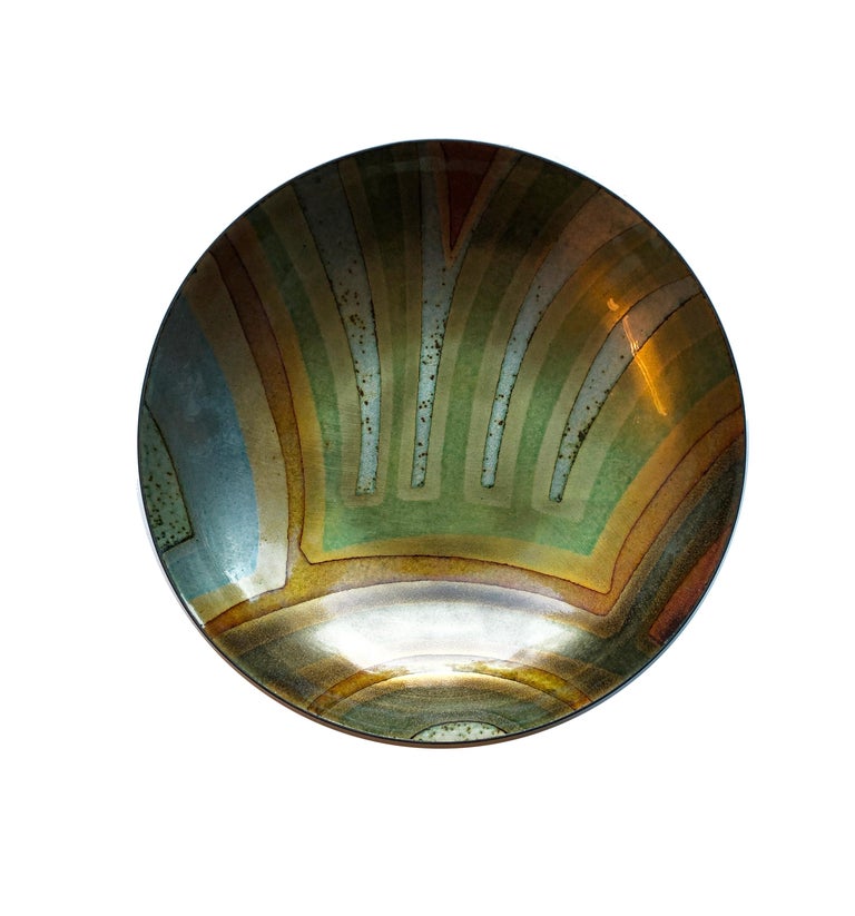 Scandinavian Modern glass enamel on copper bowl signed by Saara Hopea-Untracht, 1925-1984. Absolute fab, vibrant colors in green, orange and grey. 
From enamelarts: Saara Hopea was one of Finland’s most important designers. She was born in Porvoo,