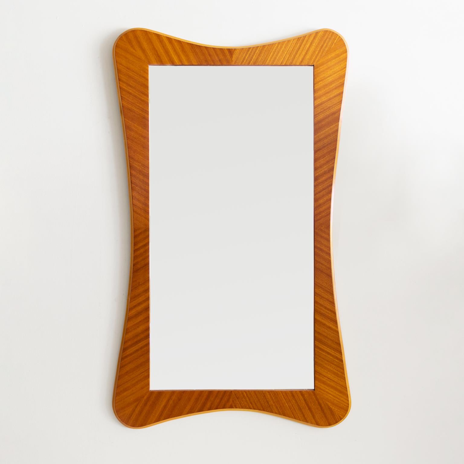 A Scandinavian modern golden hued mahogany mirror trimmed with a beechwood. The banded mahogany veneer perfectly highlights this mirror’s soft form. Made in Sweden circa 1940s with original finish and glass. 

Measures: Height 39“, width 23.25“.