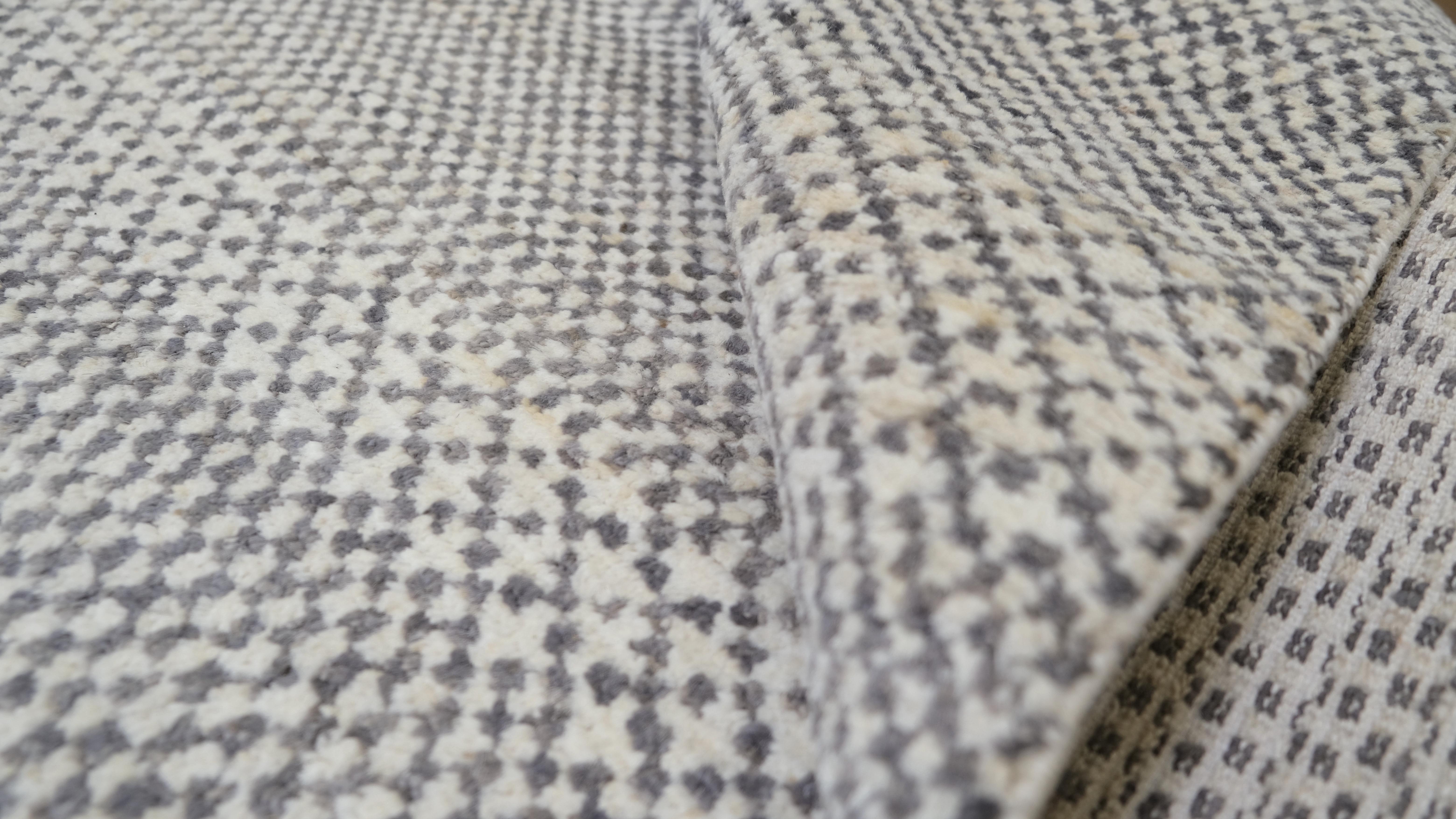 Dieser handgeknüpfte Wollteppich mit seinem modernen, geometrischen Streifendesign in einer raffinierten, neutralen Farbpalette wertet Ihre Einrichtung auf. Das subtile Zusammenspiel von Grau und Elfenbein sorgt für eine vielseitige und zeitlose