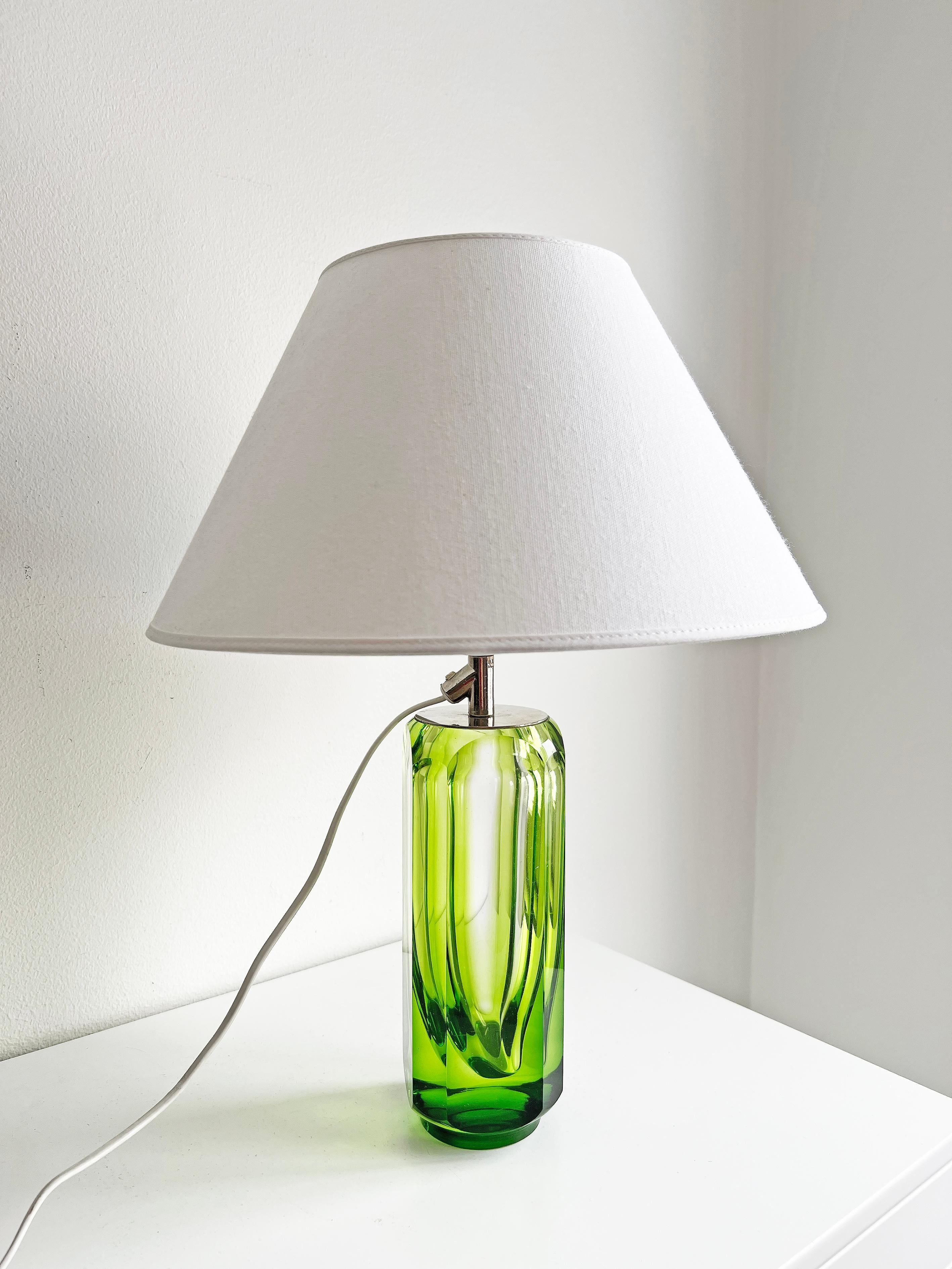 Rare table lamp with amazing green color from Reijmyre -1971.
This model is featured in Reijmyre's catalog from 1971, as shown in the last pictures.
Signed in the bottom. 
Please notice, the shade is not included. 
We recommend this lamp to be