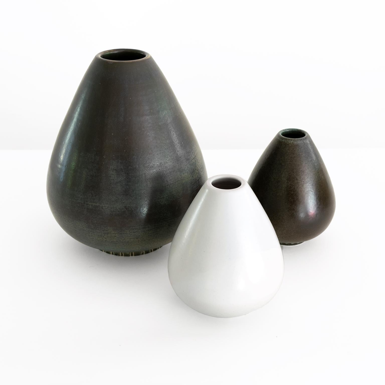 A Scandinavian Modern group of 3 Gunnar Nylund vases in light and dark glazes. Made by Rorstrand, Sweden, circa 1945-1950. 

Measures: Height 11” x diameter 6.5”, heights 6.5” x diameters 5”.