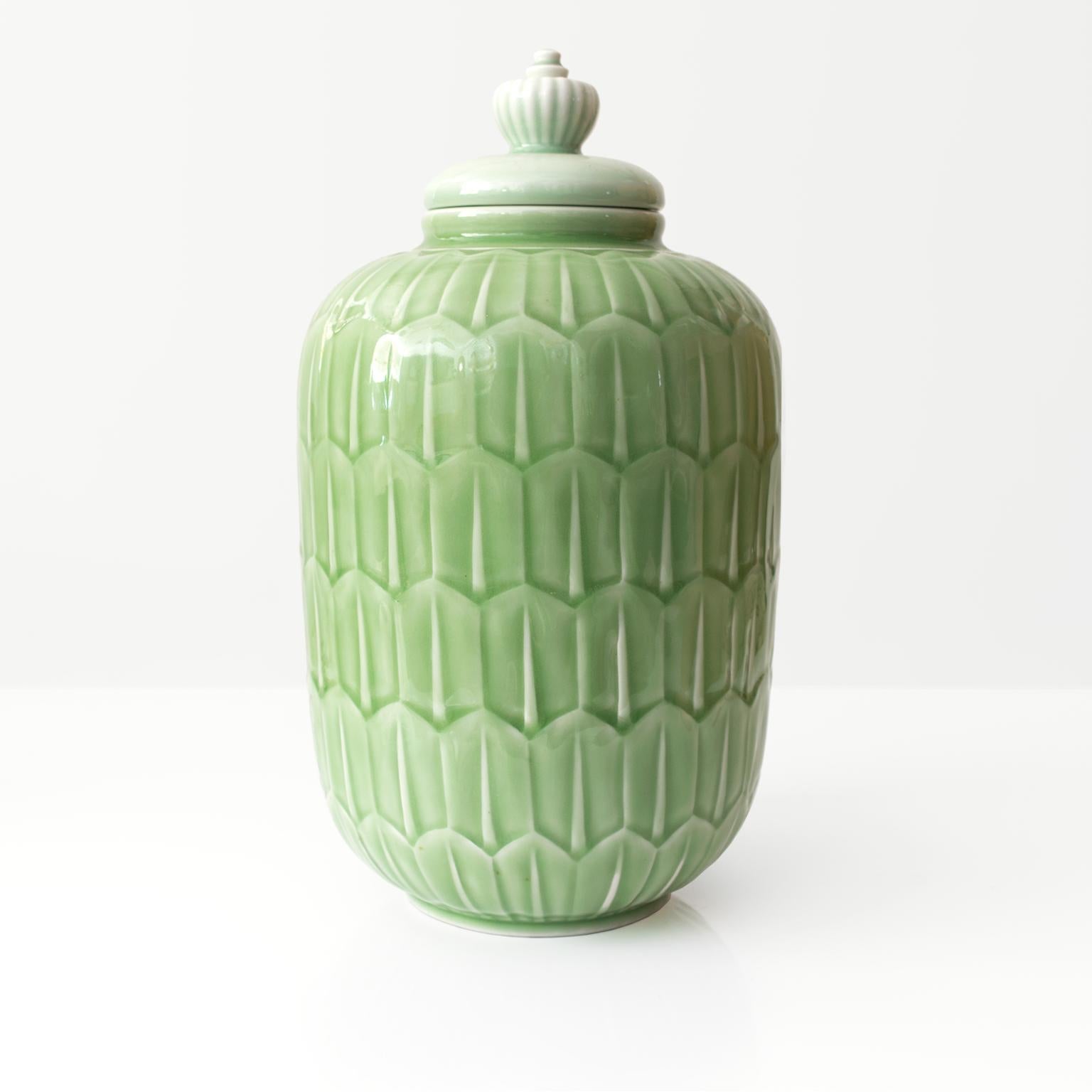A large elegant Scandinavian Modern jaded colored glaze on a raised pattern ceramic jar with lid. Designed by Gunnar Nylund for Rörstrand, Sweden, circa 1940. 

Measures: Height 14.5