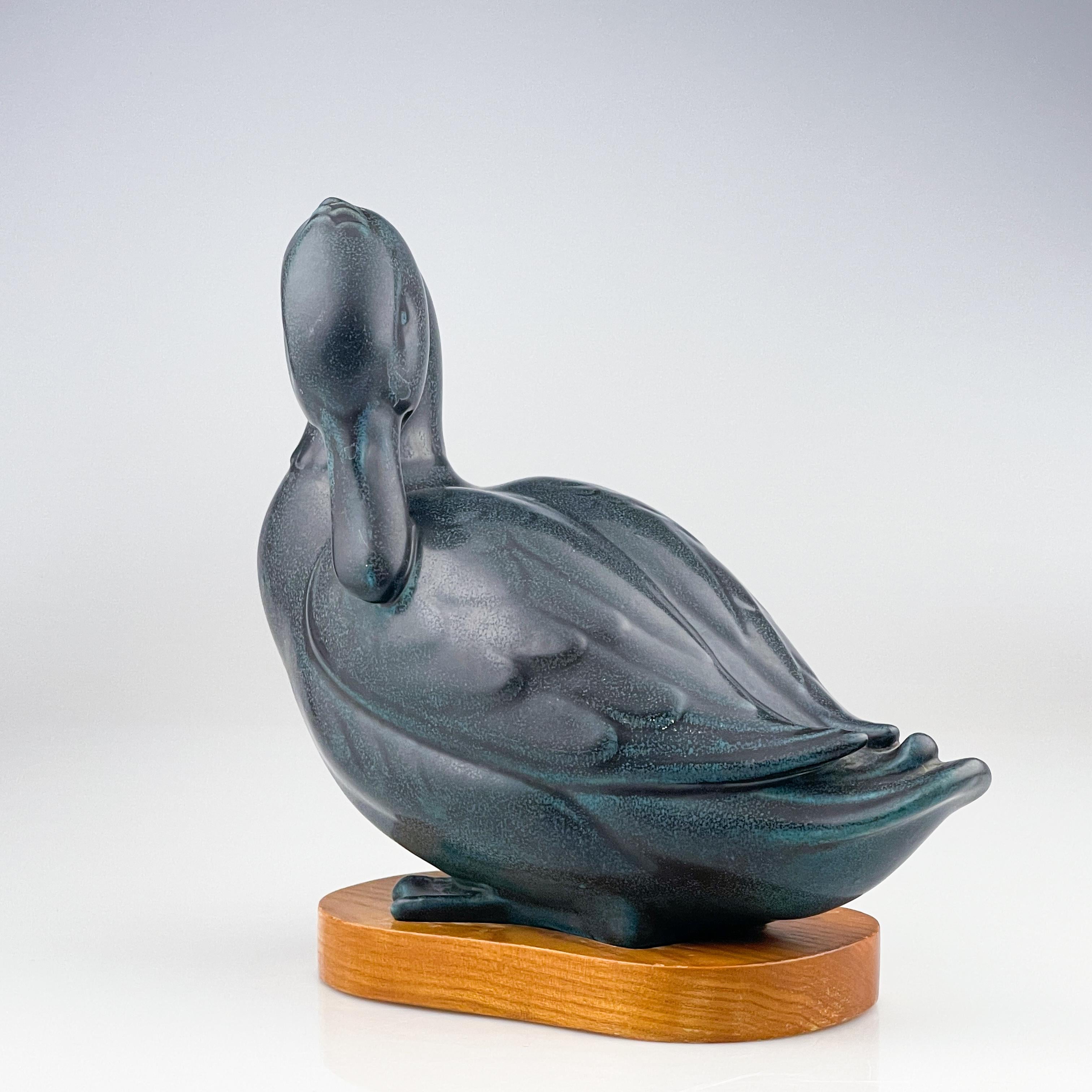 Gunnar Nylund, Stoneware Sculpture of a Duck, Rörstrand, Sweden, circa 1950

Description
A stoneware sculpture of a Duck, finished in blue and green glazes on it’s original lacquered wooden base. Made in a limited edition of 200 pieces.

Gunnar