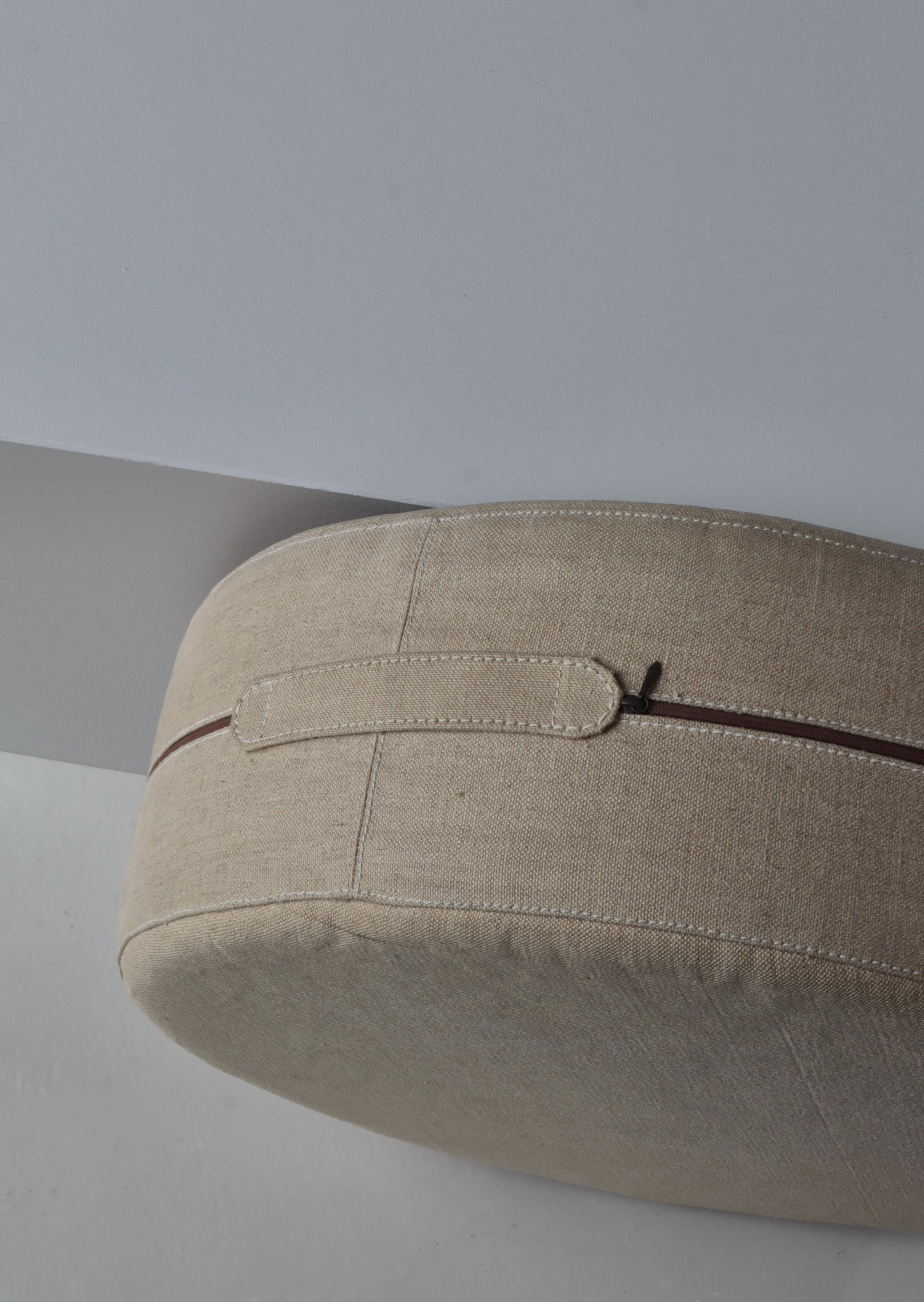 Handmade pouf or side table designed and handmade by Ivan Schlechter at his own workshop in the mid 1960s. The pouf is upholstered in thick natural canvas, features a handle and is hand sewn. The design is simple and functional typical for Danish