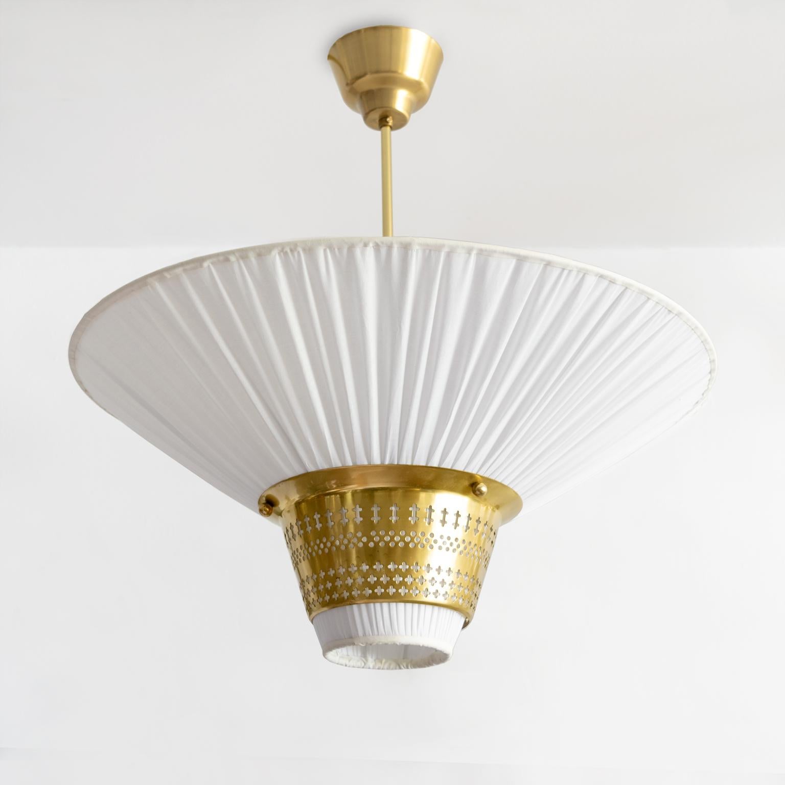 Hans Bergstrom designed for Ateljé Lyktan AB funnel form pendant with pleated cotton cover (newly redone) and a pierced brass 