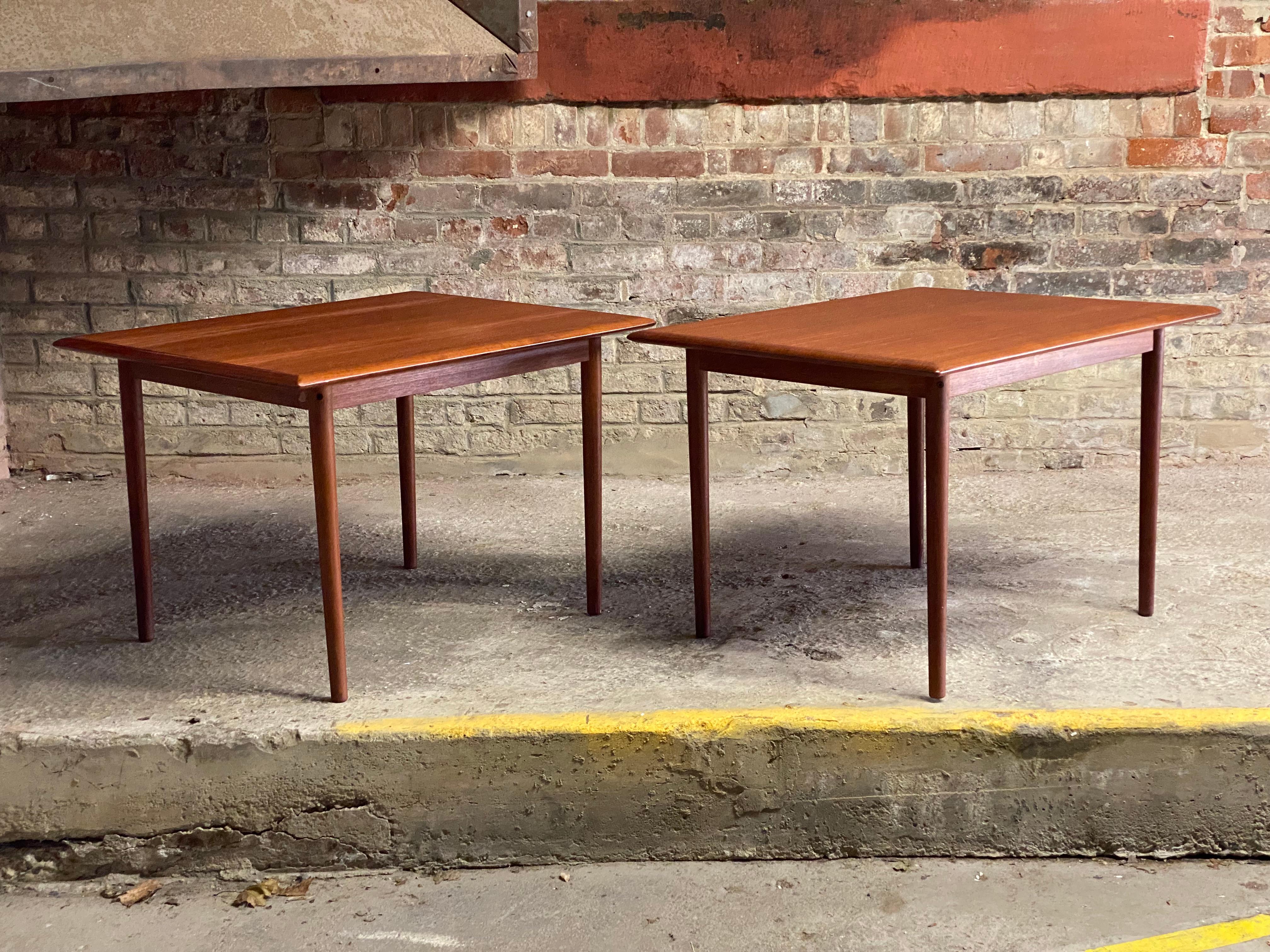A fine pair of teak side tables by Haug Snekkeri, A/S, Norway. Both examples are signed on the underside. Featuring removable tapered solid teak legs, mitered corner tops with beautifully figured teak veneers. Flat pack construction. Circa 1960.