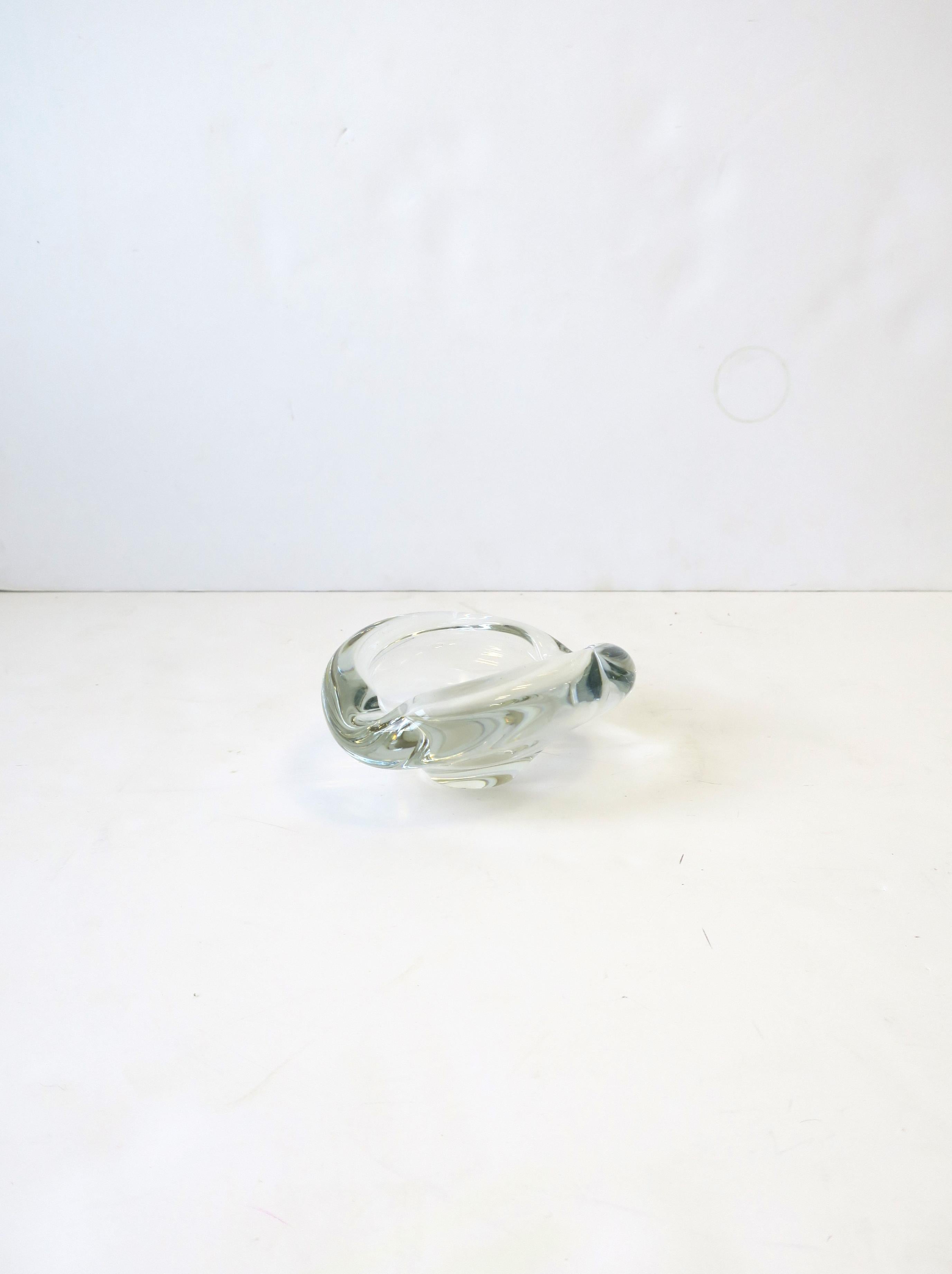 A beautiful and substantial signed Scandinavian Modern Danish modern clear/transparent art glass bowl or ashtray, 1958, Denmark, by Holmegaard. Bowl has marker's mark (Holmegaard), year (1958), and artist initial in-between year, all on bottom base