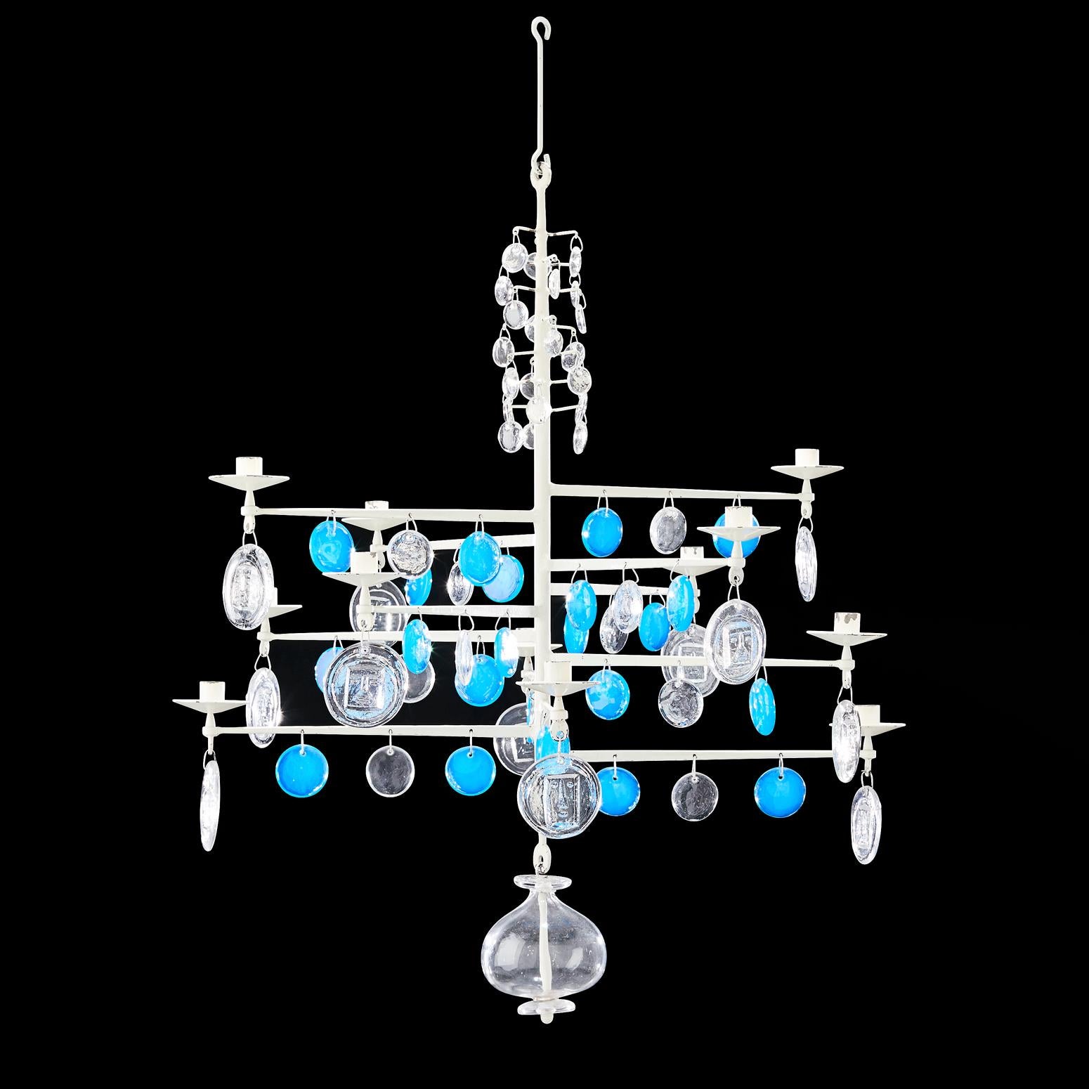 A are, Scandinavian Modern chandelier in wrought steel structure designed by Erik Hoglund (Höglund) and executed by Boda Nova Glassworks / Axel Stromberg Ironworks, Sweden, 1971. 
It is suited for 12 candles, ornamented with blue and clear, mouth