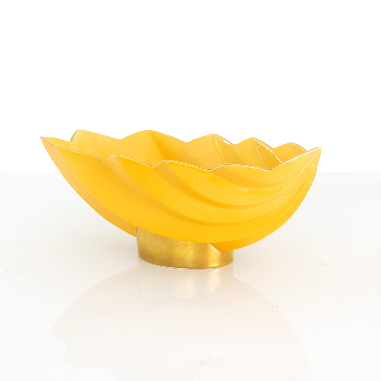 A large elegant Scandinavian Modern yellow colored glaze ceramic footed bowl with gold details. Designed by Karin Bjornquist for Rörstrand, Sweden, signed and dated 1996 on the bottom.

Measures: Height 8” width 7” depth 12.5”.