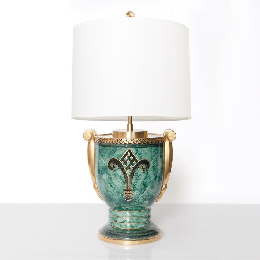Scandinavian Modern ceramic table lamp in luster glaze with hand decorations in gold. Designed by Josef Ekberg for Gustavsberg, signed and dated 1928. Fitted with newly polished and lacquered brass hardware and a double socket cluster. Measures:
